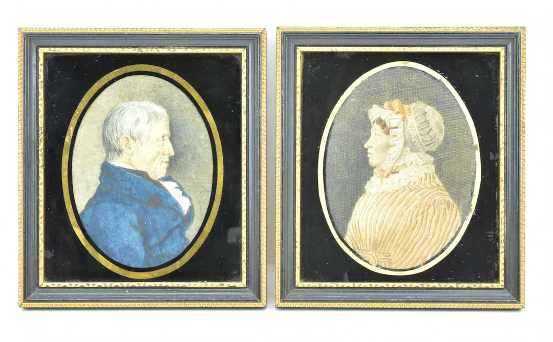 A pair of early 19th century miniature watercolour on paper portraits