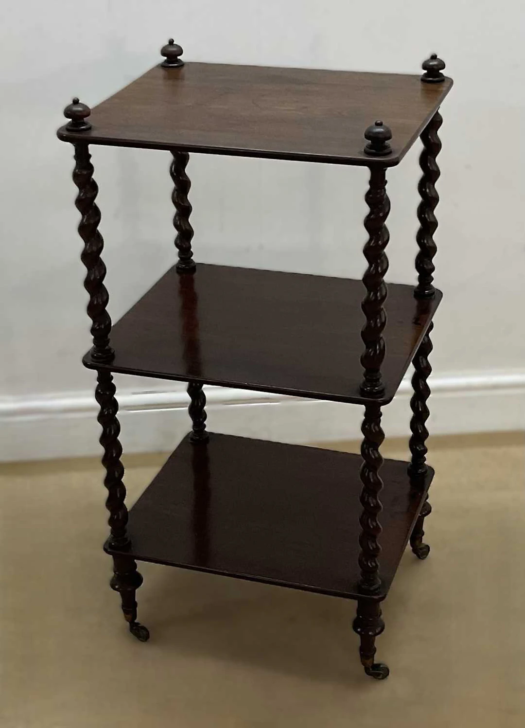 A mahogany three shelf whatnot with barley twist supports