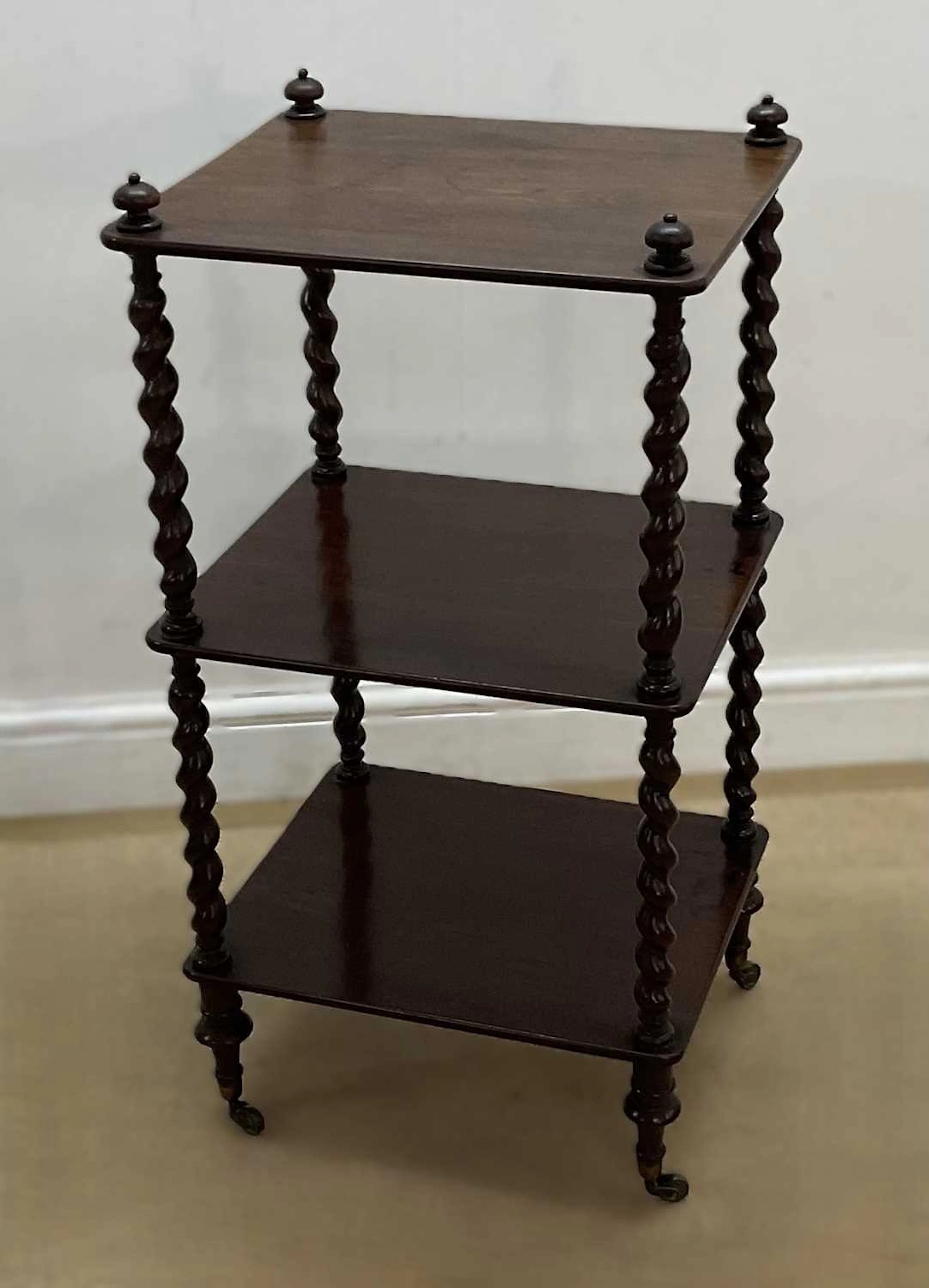 A mahogany three shelf whatnot with barley twist supports