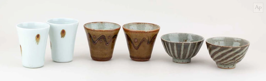 EDWARD HUGHES (1953-2006); a pair of porcelain beakers...