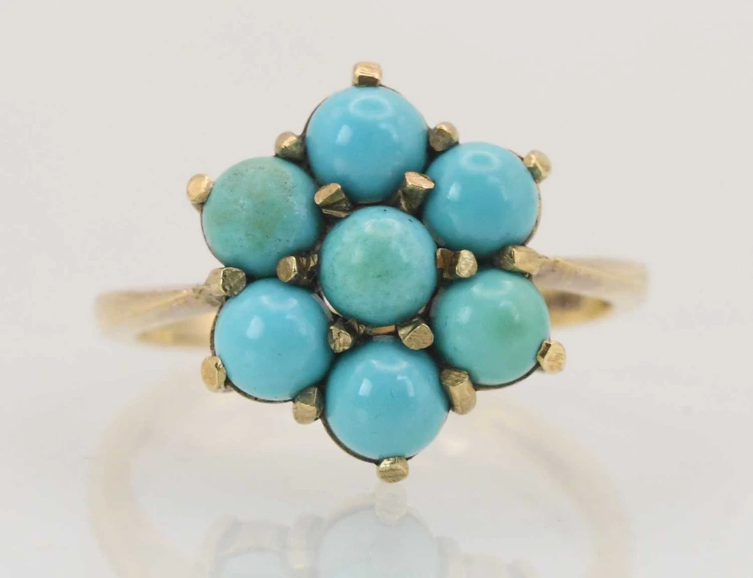 A 9ct yellow gold turquoise set flower head cluster ring