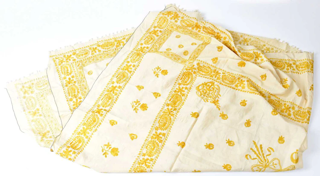 A 20th century Indian silk cloth cream ground with gold coloured embroidery