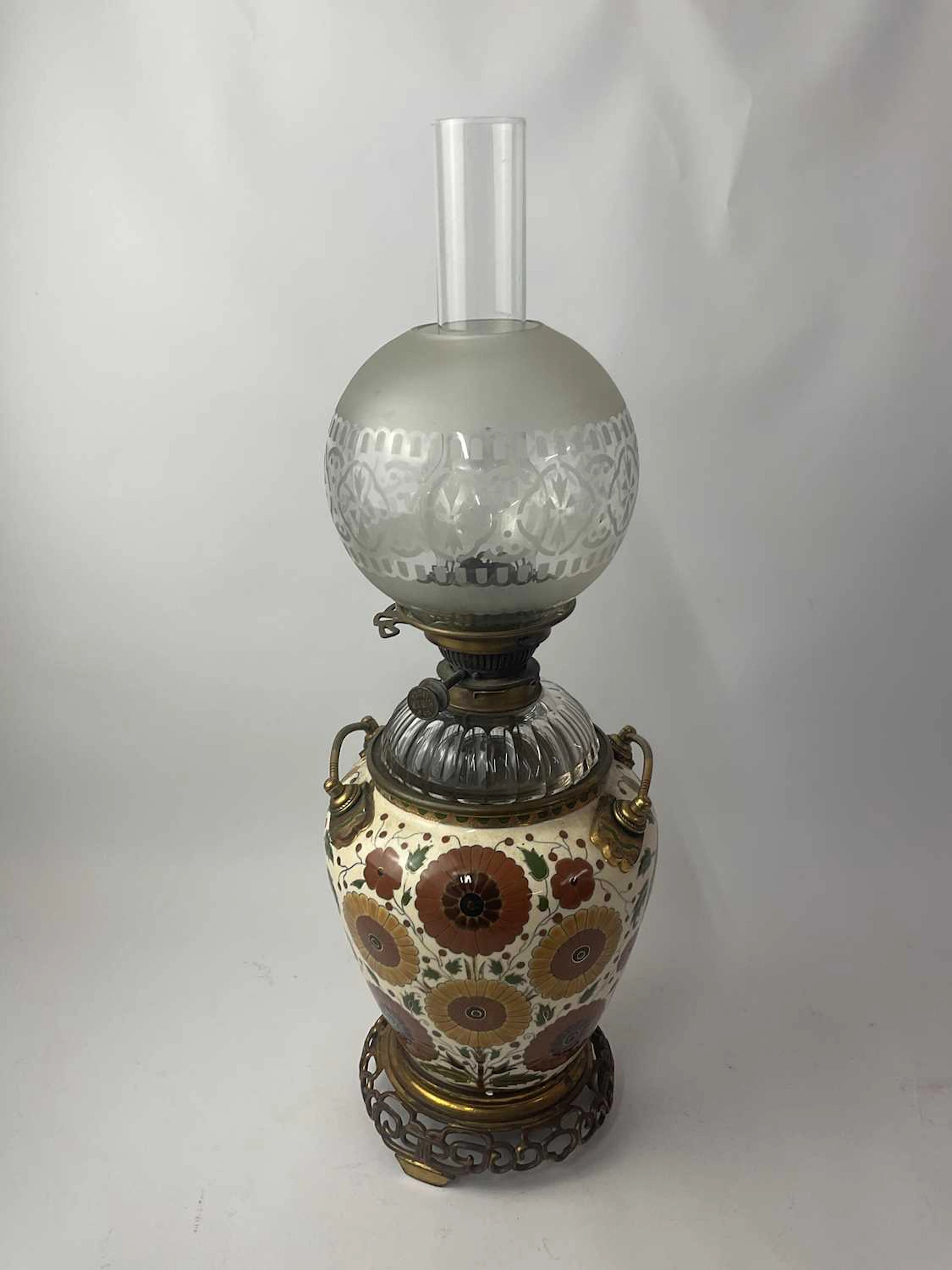 A 19th century converted oil lamp having a ceramic body...