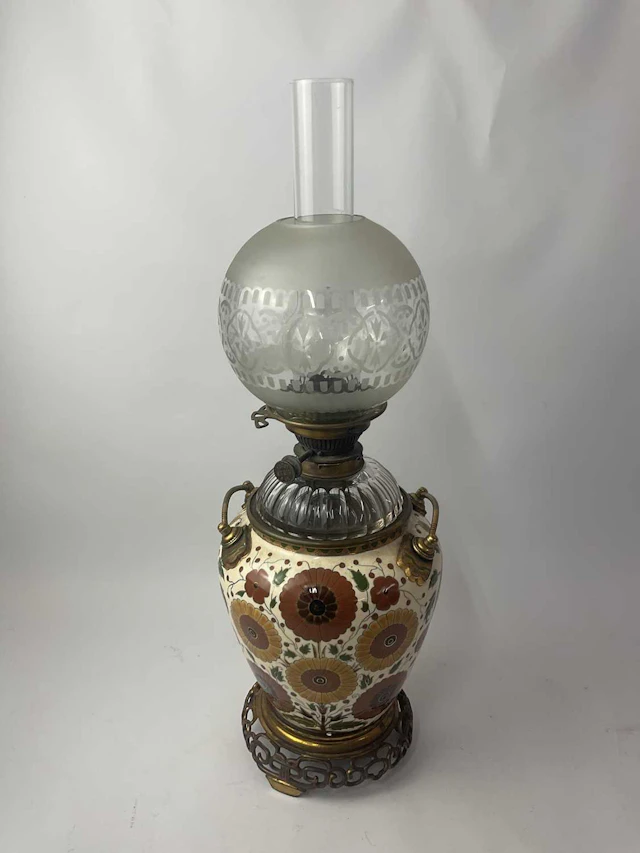 A 19th century converted oil lamp having a ceramic body...