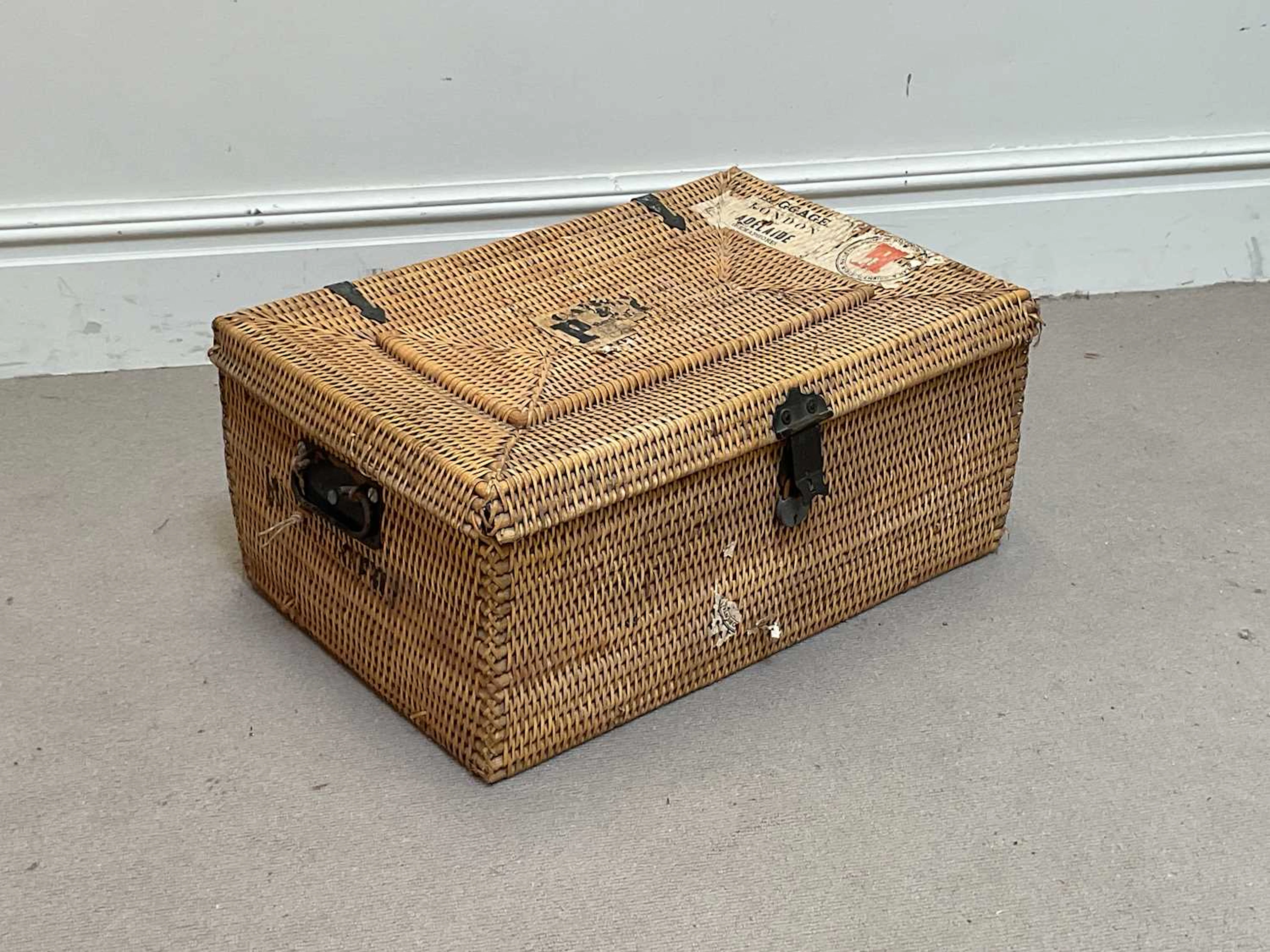 An early 20th century wicker travelling trunk