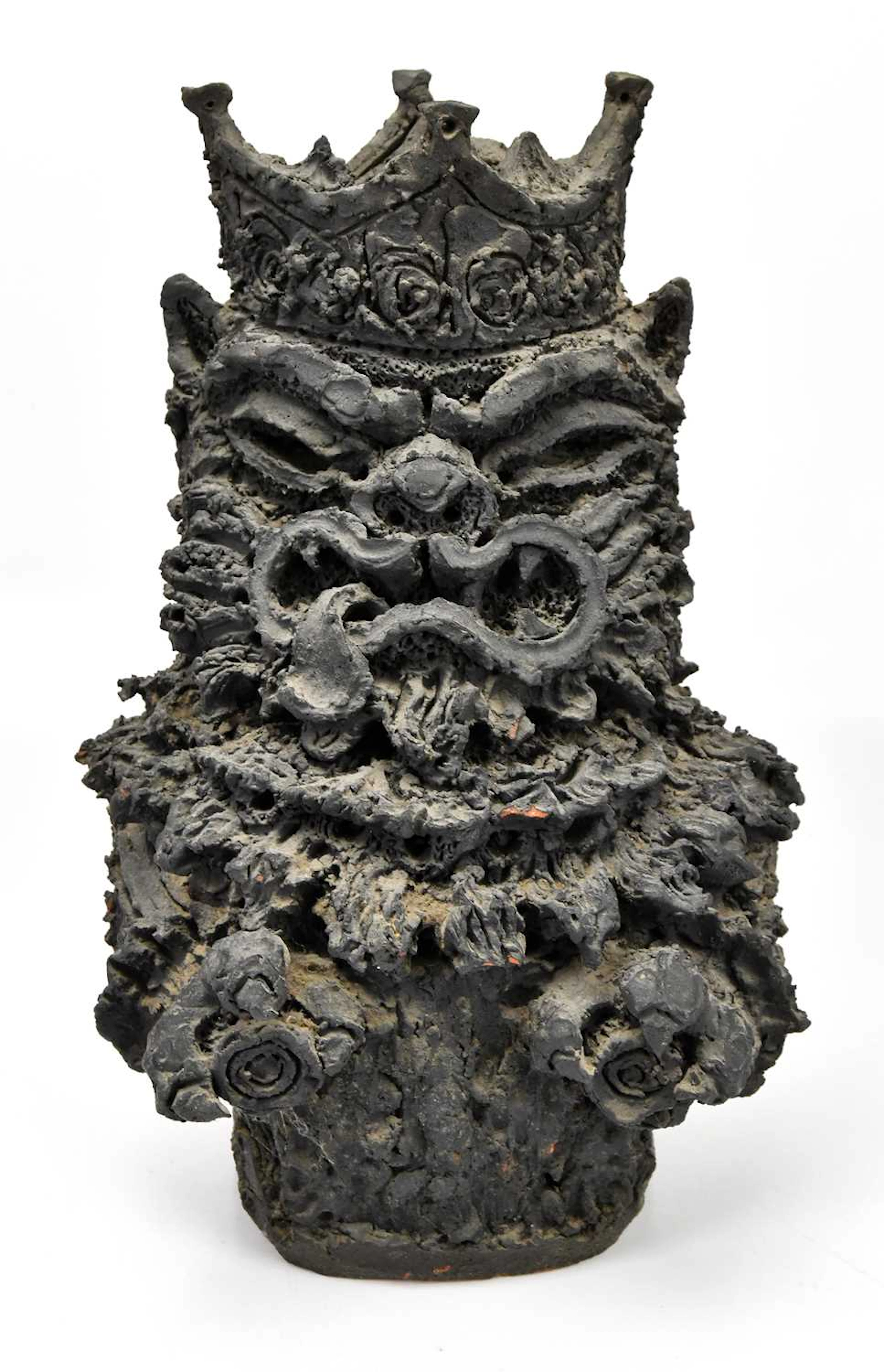 A possibly Japanese terracotta sculpture with grotesque face wearing a crown