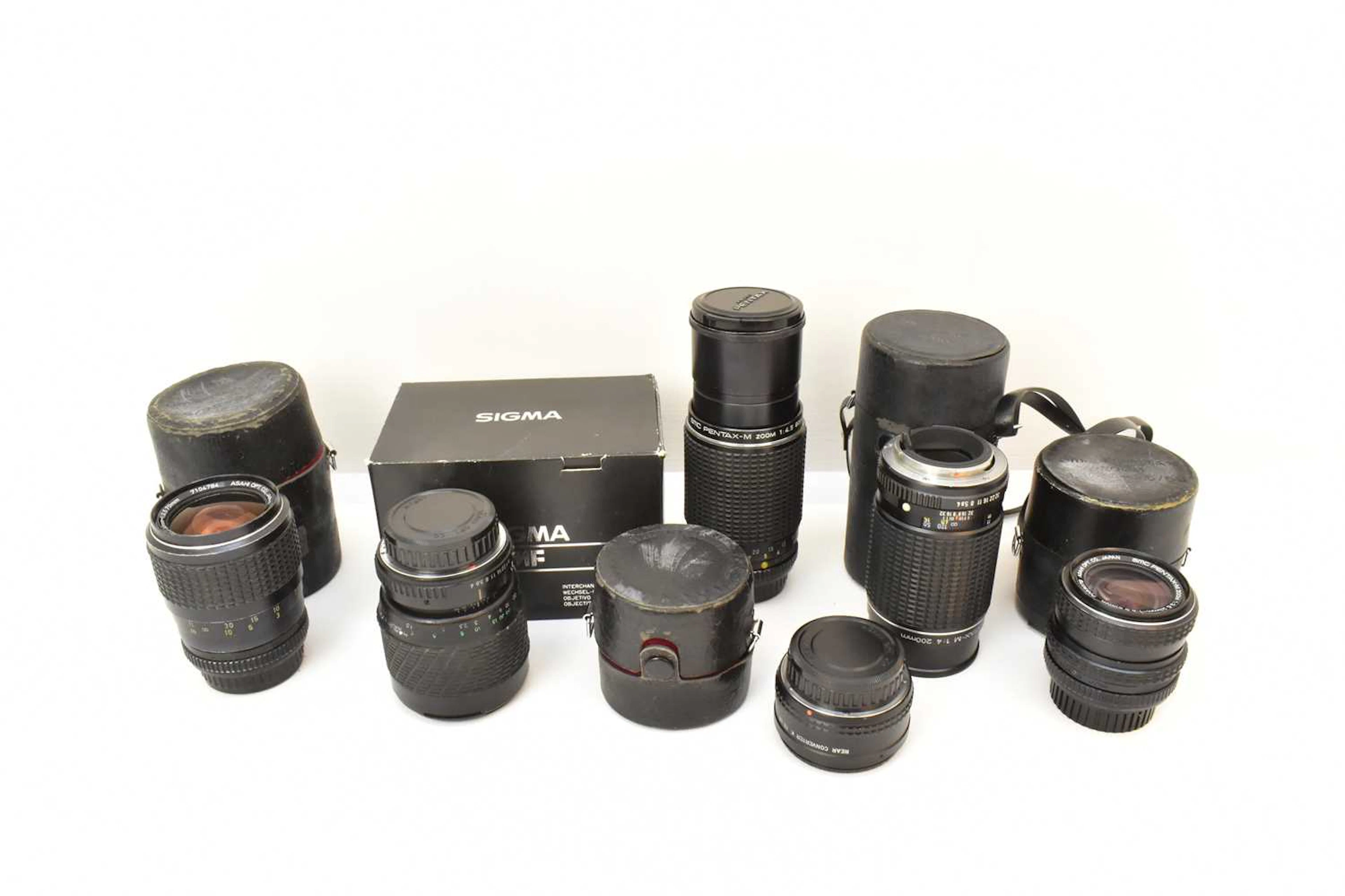 Six camera lenses comprising SMC Pentax-M Zoom 1:2.8 35mm-70mm