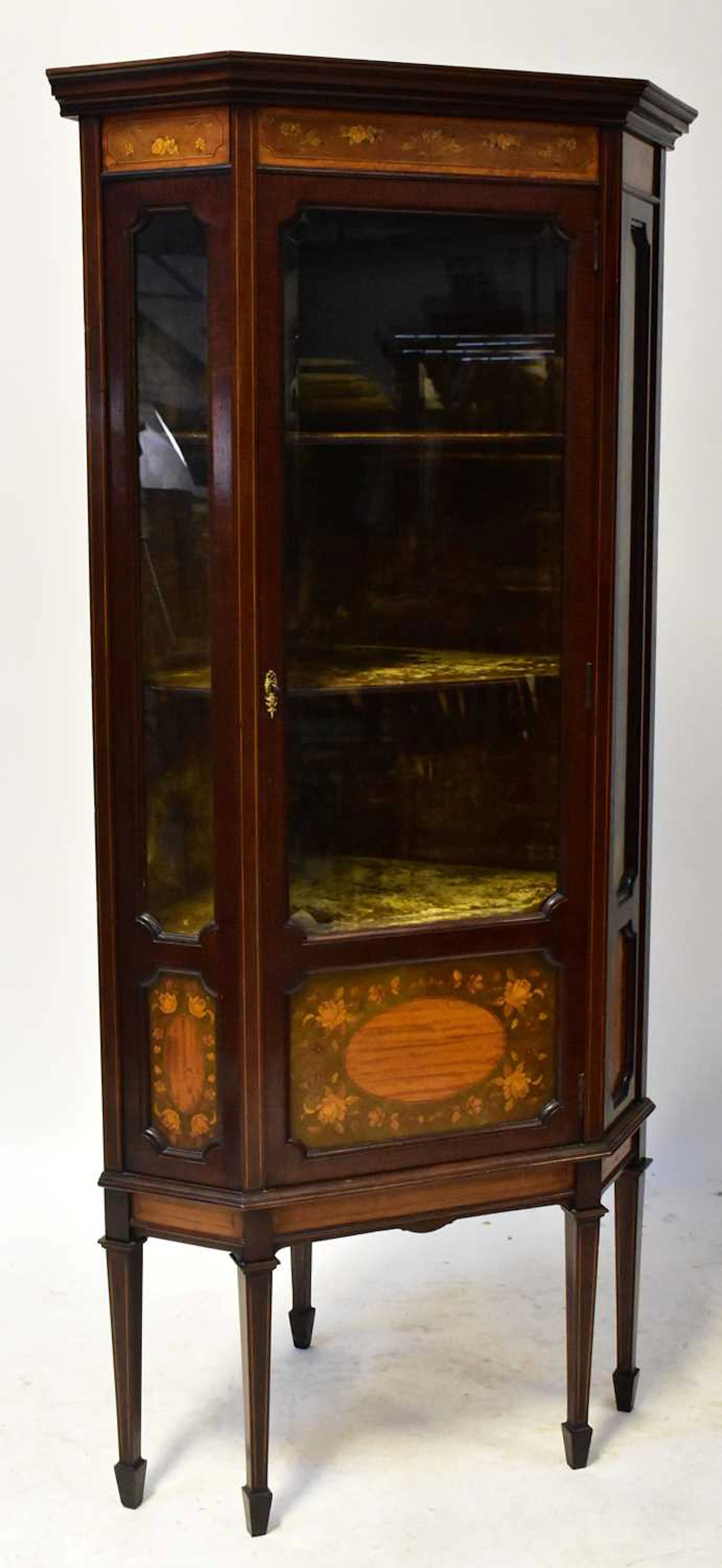 An Edwardian Sheraton-style inlaid mahogany glazed floorstanding corner cabinet