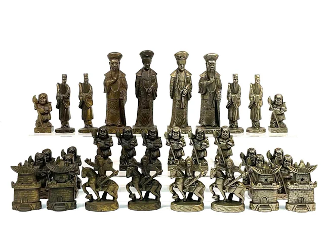 A thirty-two piece figural chess set with Asian inspired...