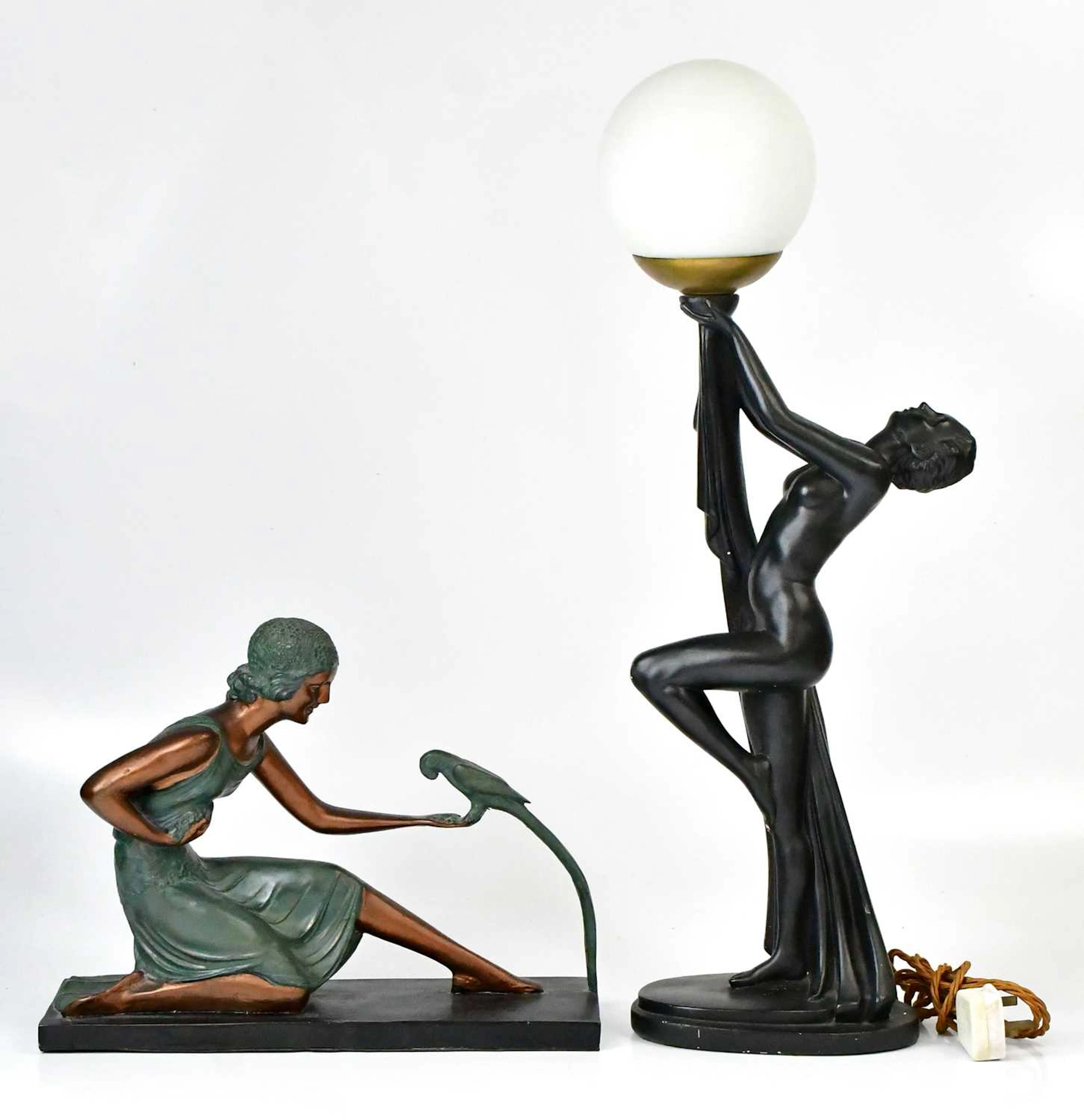 An Art Deco style lamp with a nude lady holding aloft a...