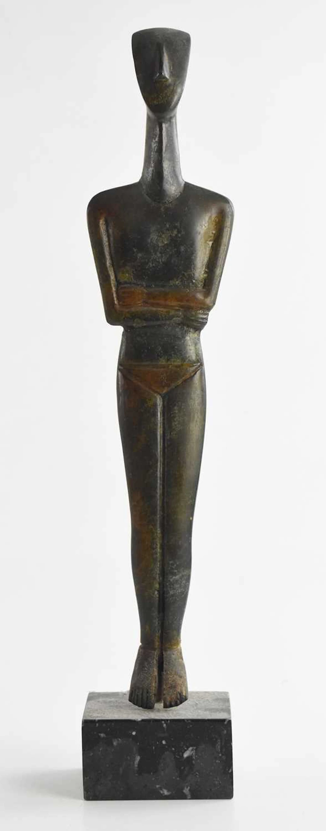 A bronze Cycladic folded arm figure