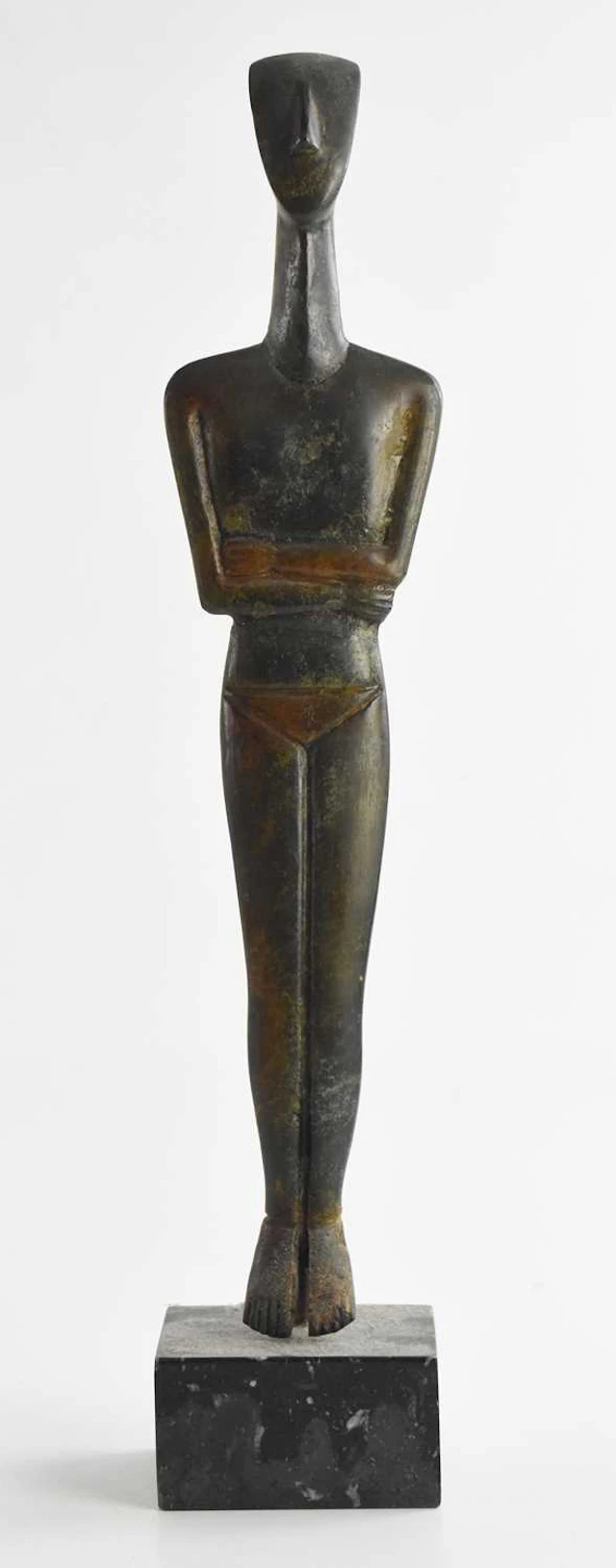 A bronze Cycladic folded arm figure