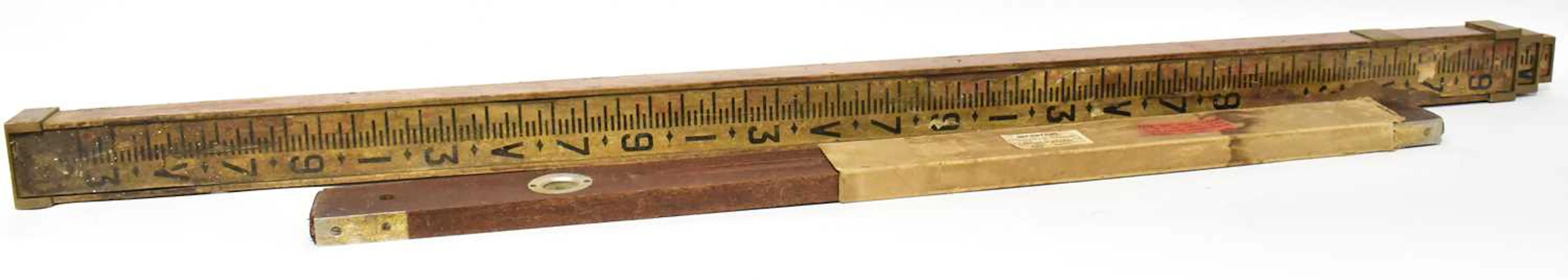 A vintage surveyor's three-sectioned telescopic measuring stick