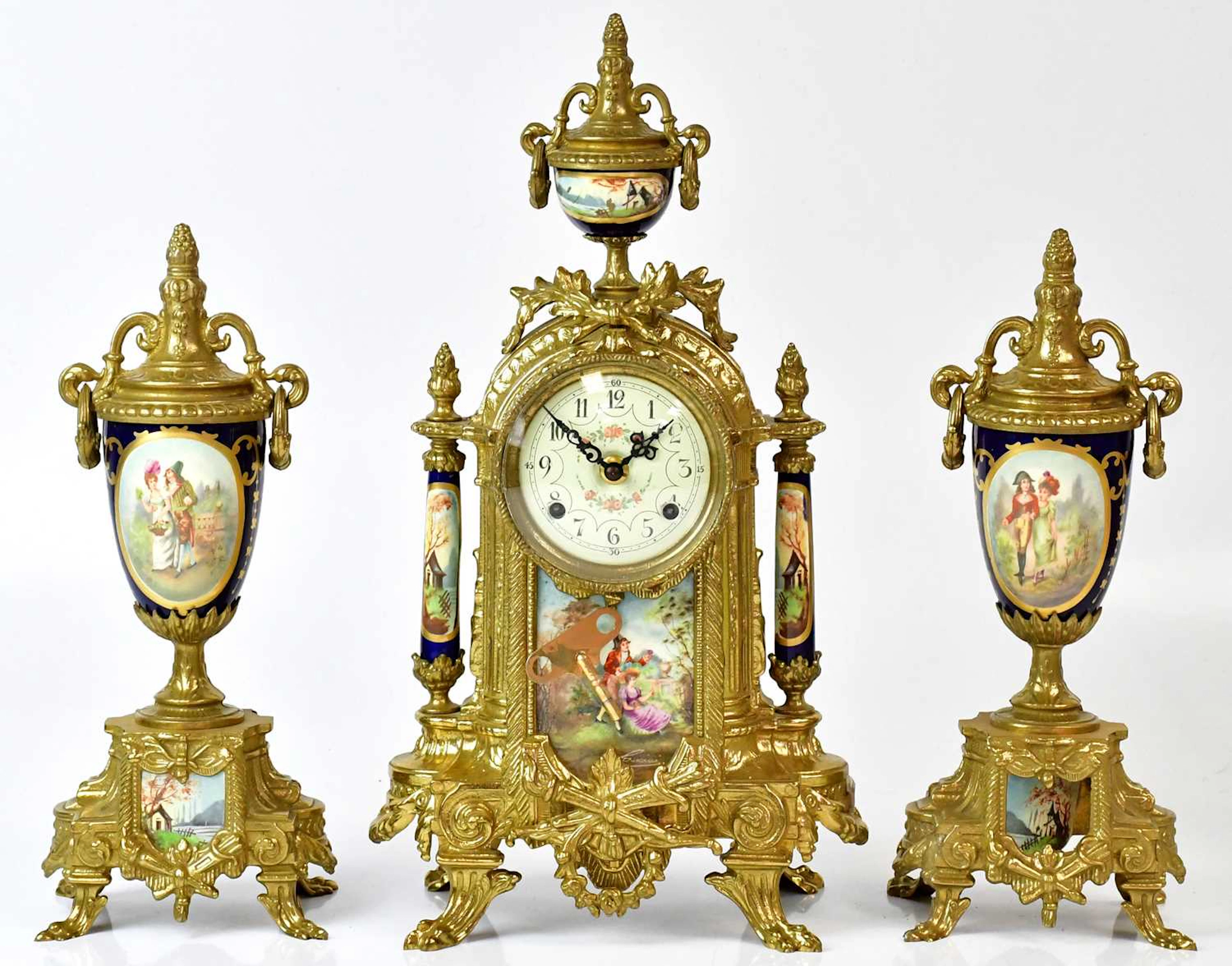 A 19th century style French clock garniture of Neo-classical form