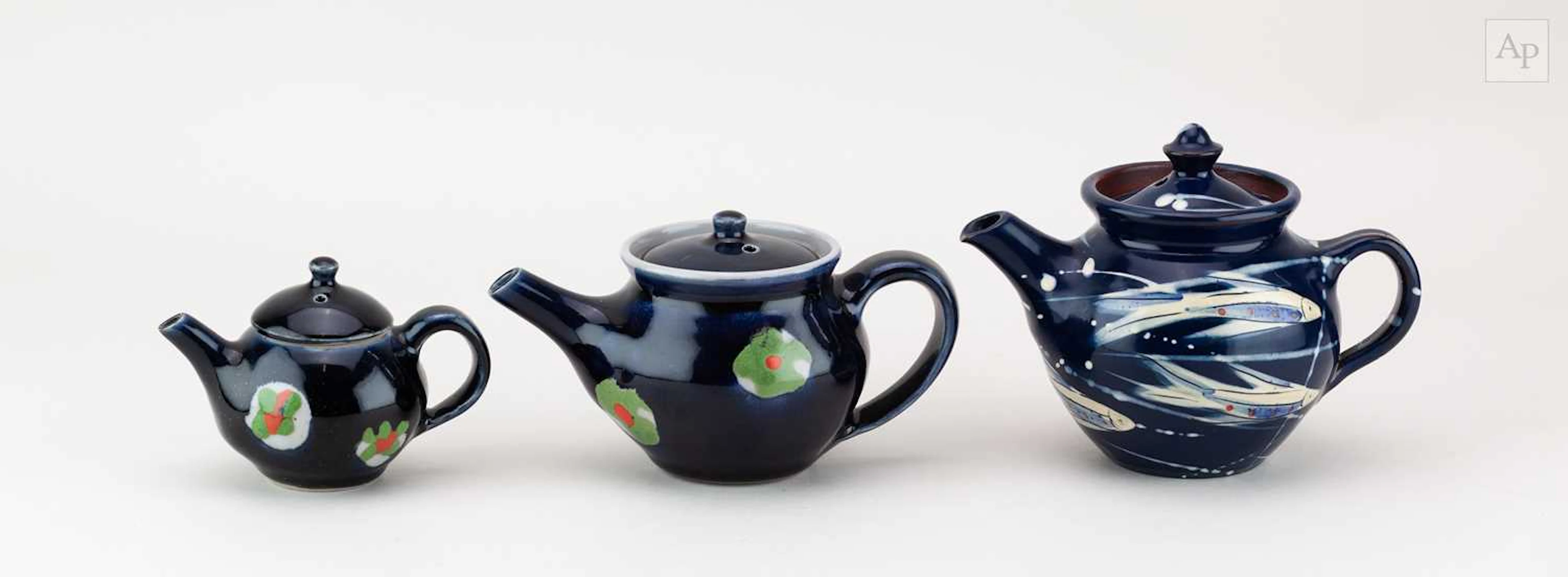 ELIZABETH GALE; a graduated trio of small stoneware and slipware teapots