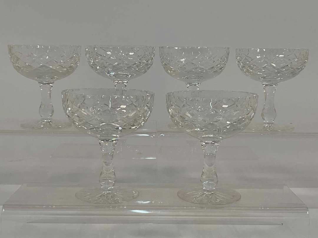 A set of six cut crystal champagne coupes with diamond cut pattern