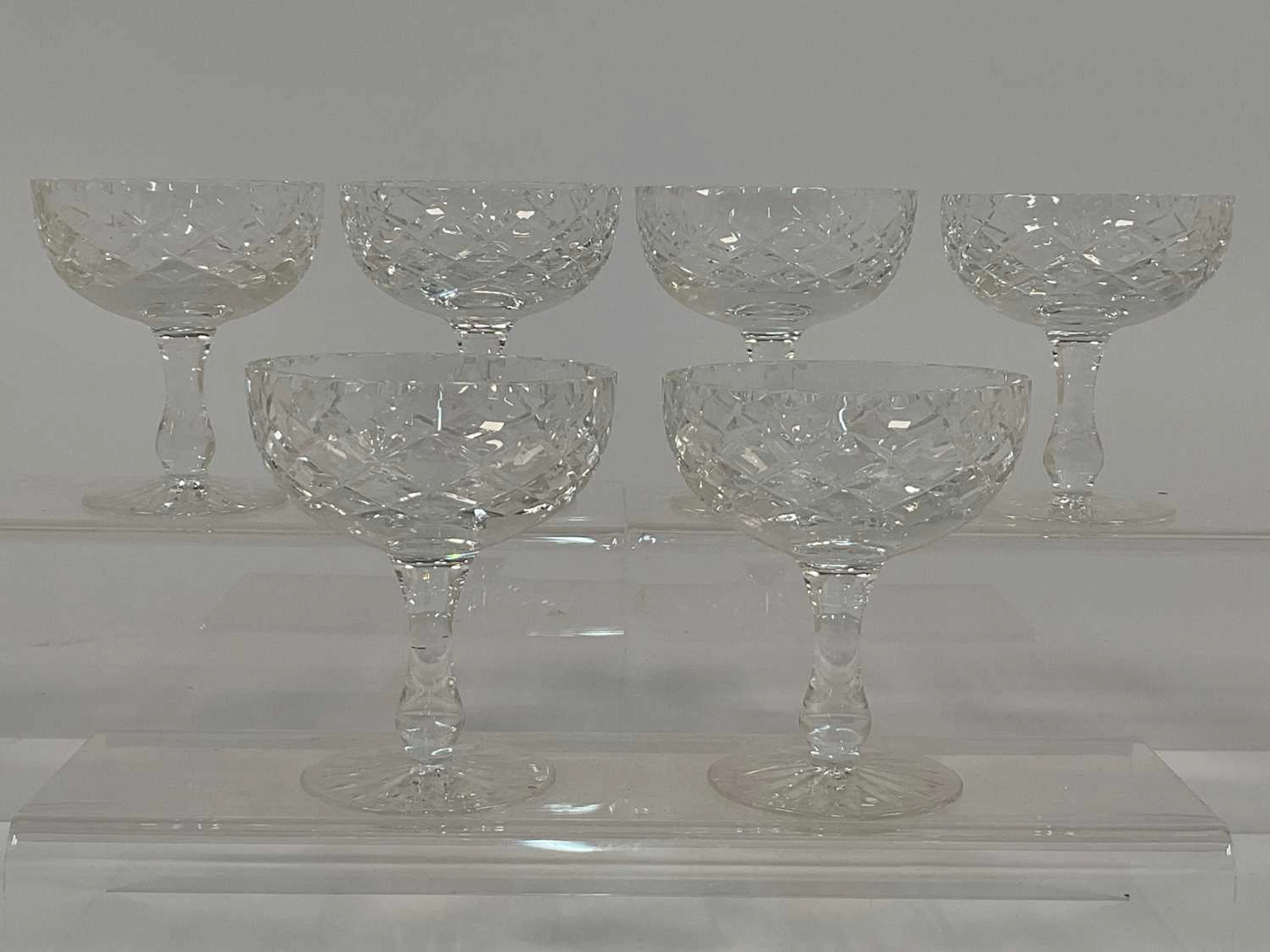 A set of six cut crystal champagne coupes with diamond cut pattern