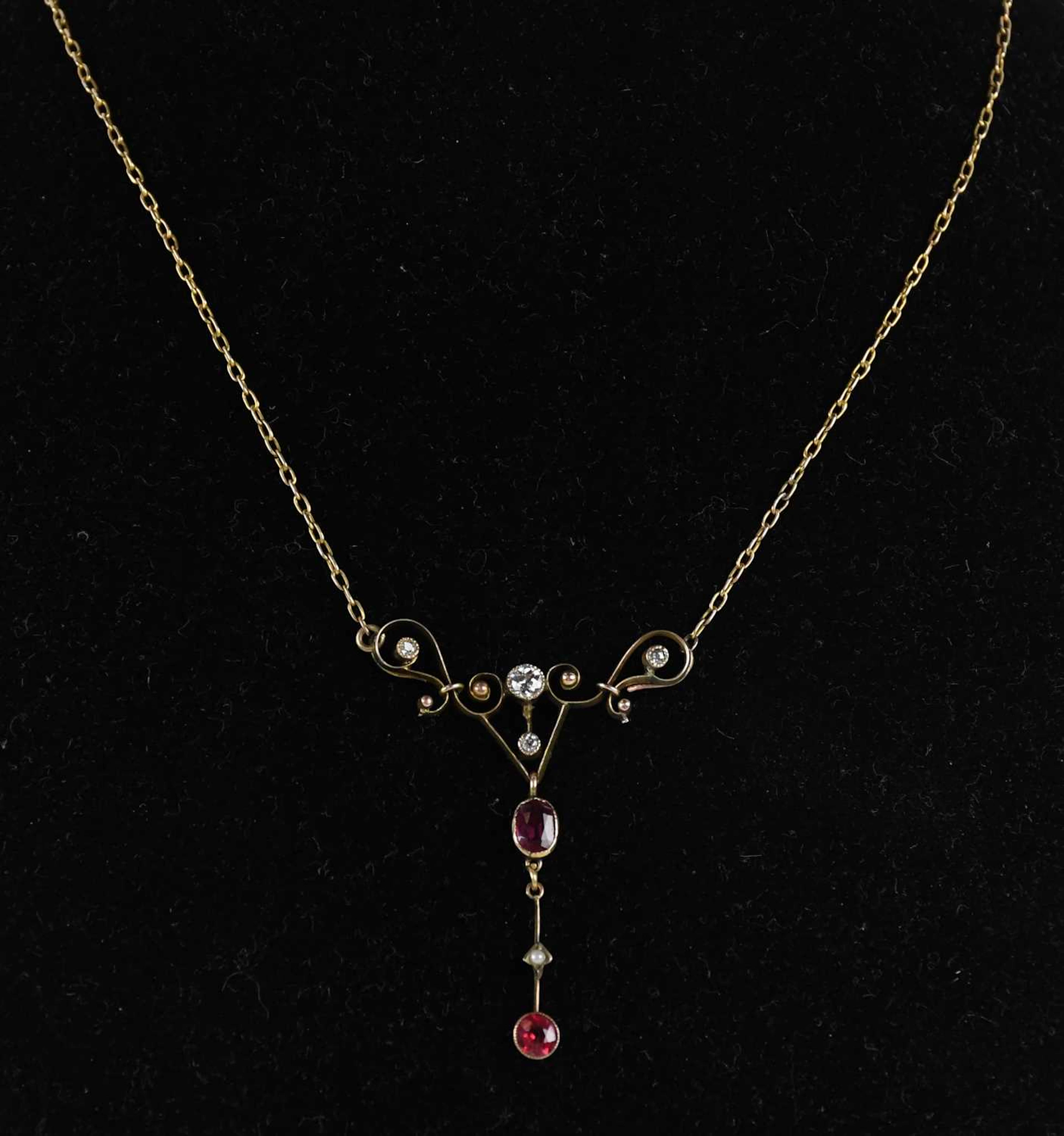 An Edwardian yellow metal Art Nouveau ruby and diamond set necklace