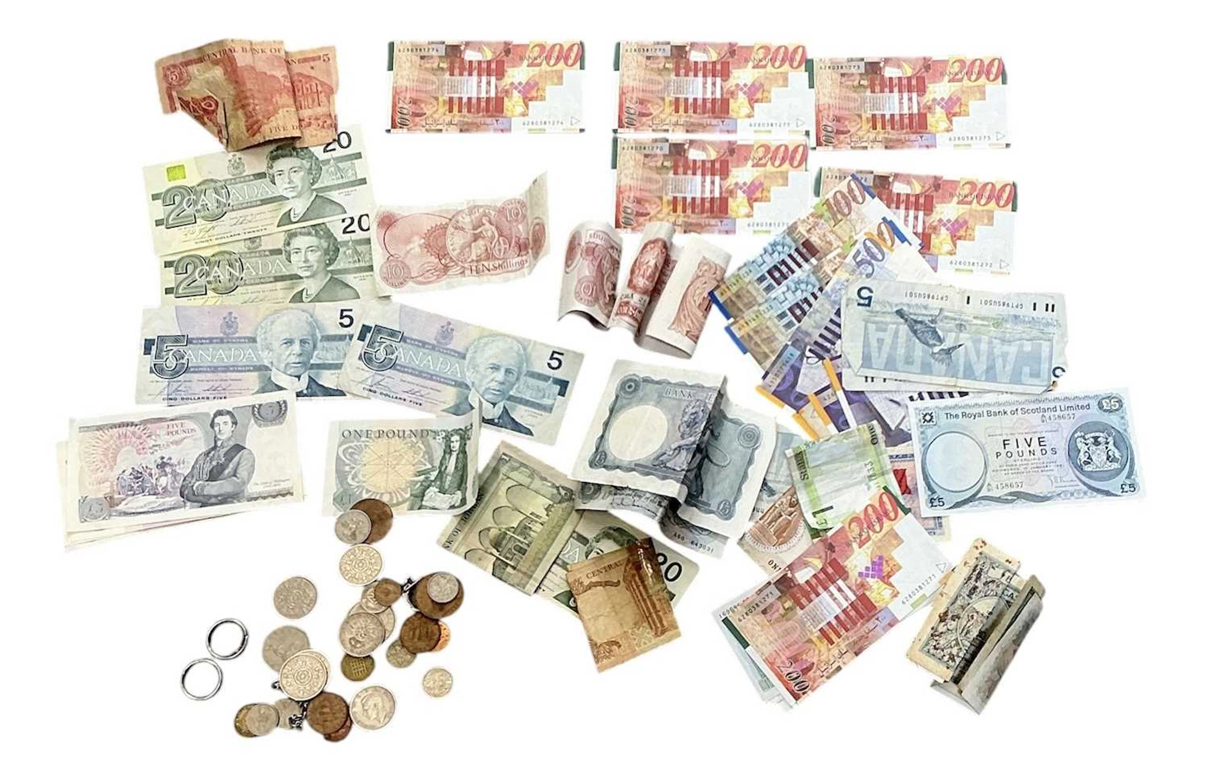 A quantity of assorted all world coins and banknotes