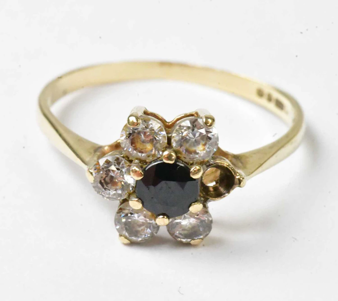 A 9ct yellow gold ring set with a central blue stone