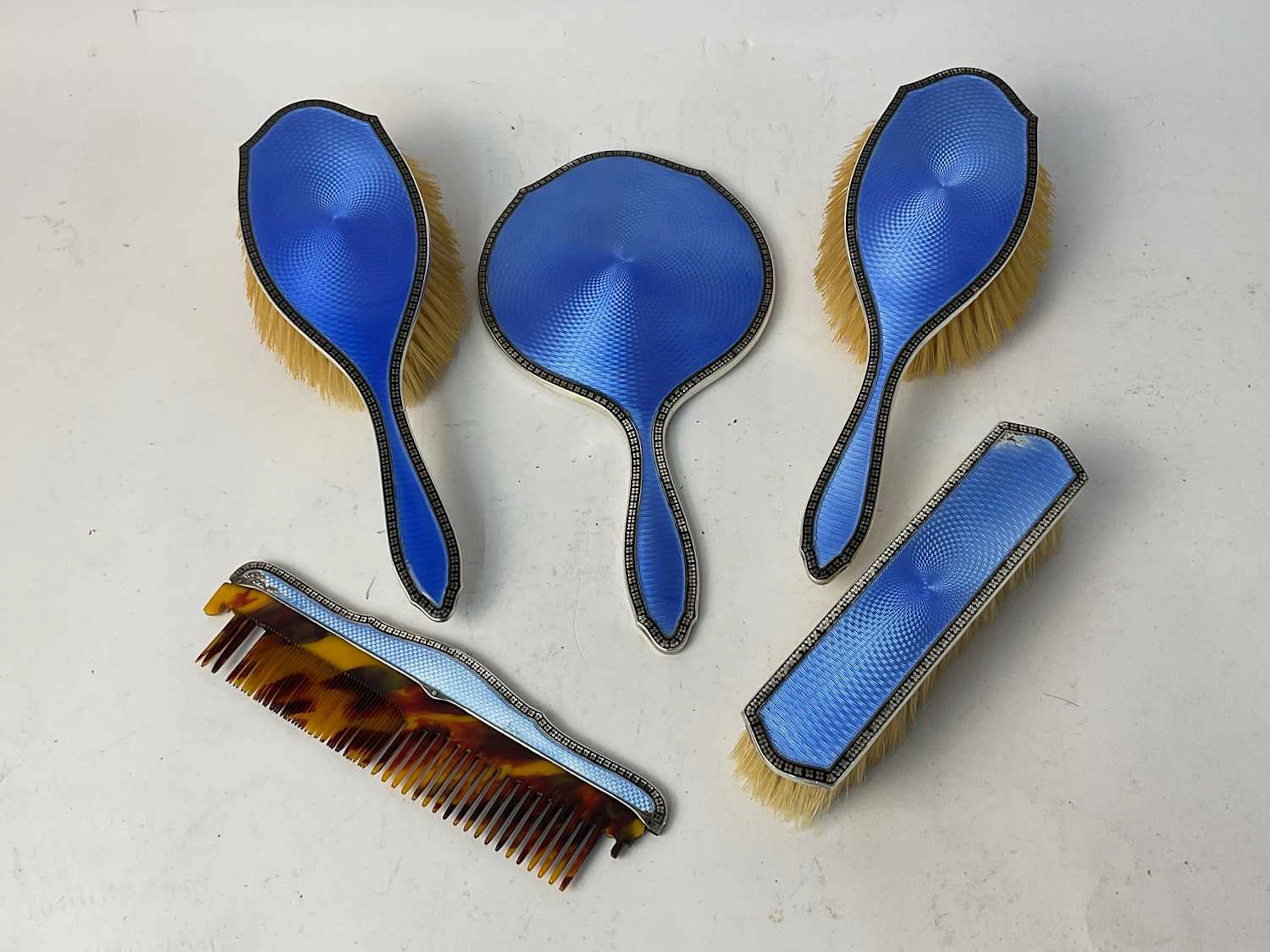 A five piece hallmarked silver dressing table set