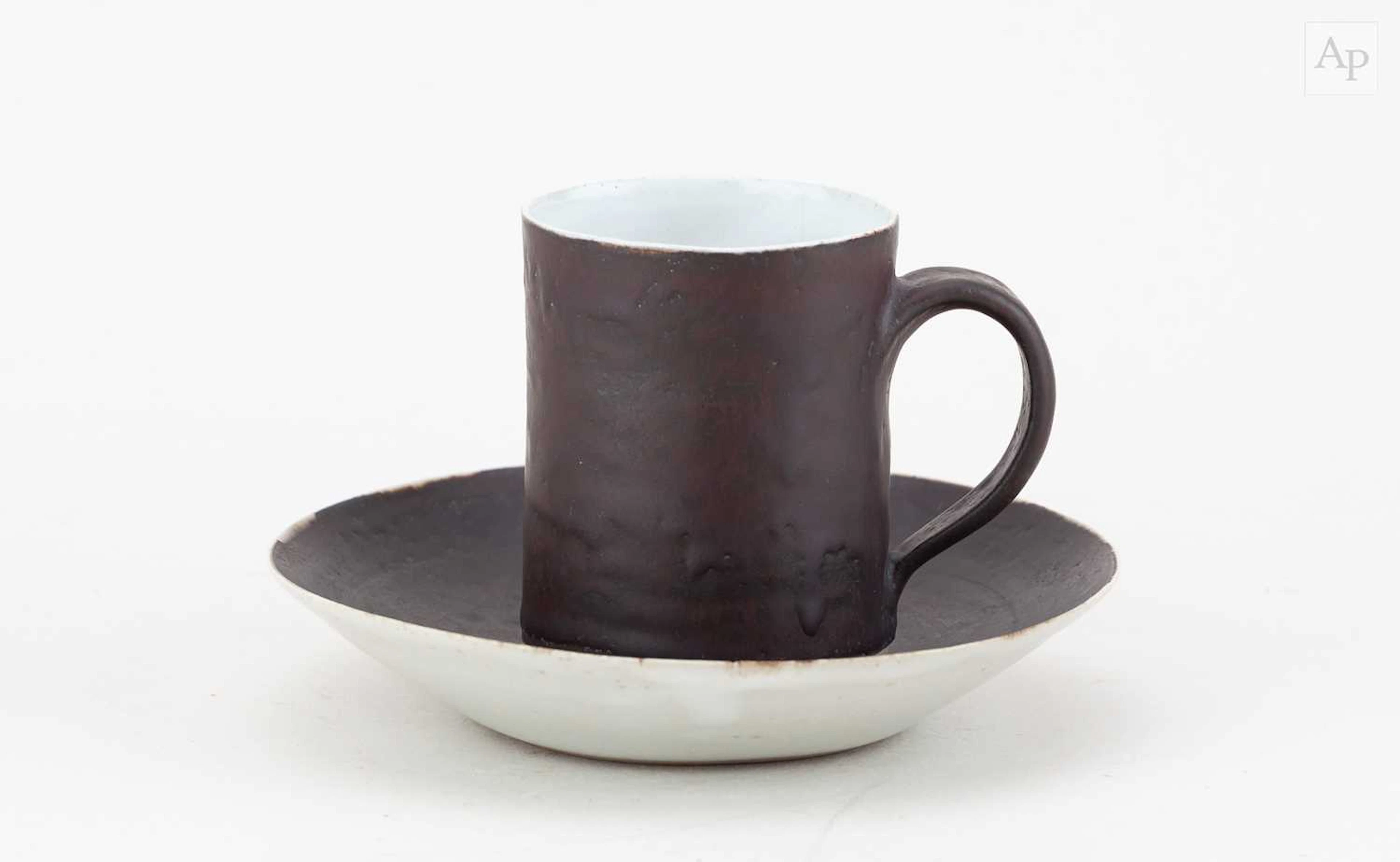 LUCIE RIE (1902-1995); a stoneware cup and saucer covered...