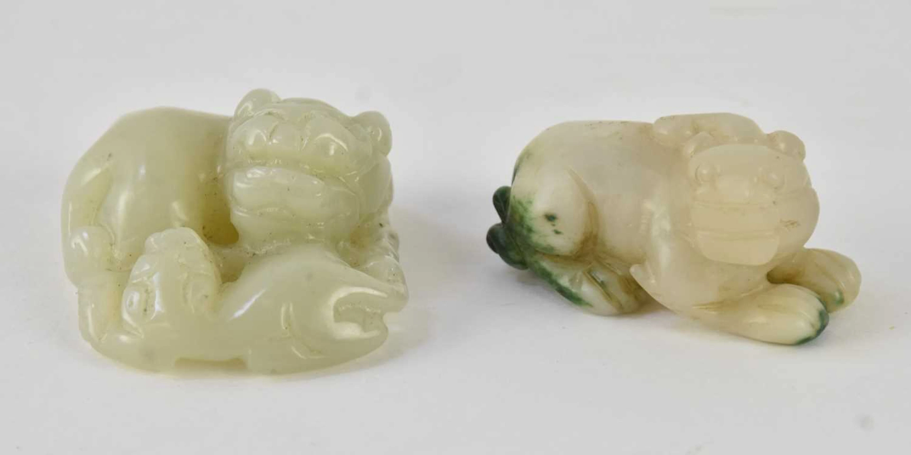A small Chinese carved green jade figure of a recumbent dog