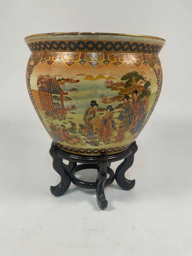 A Japanese fish bowl decorated with figures in a landscape setting