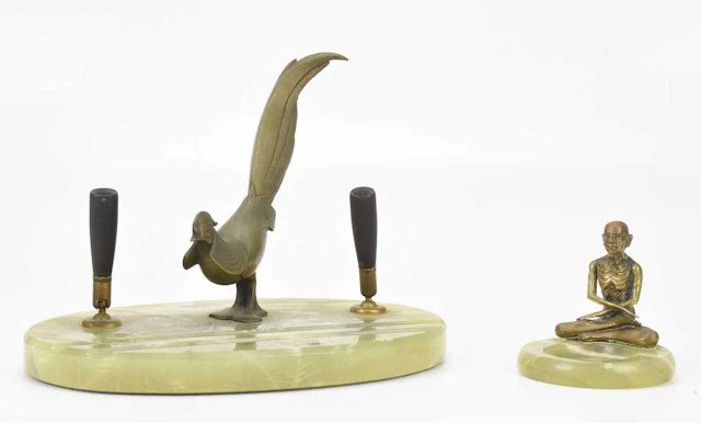 An Art Deco desk stand representing a brass peacock
