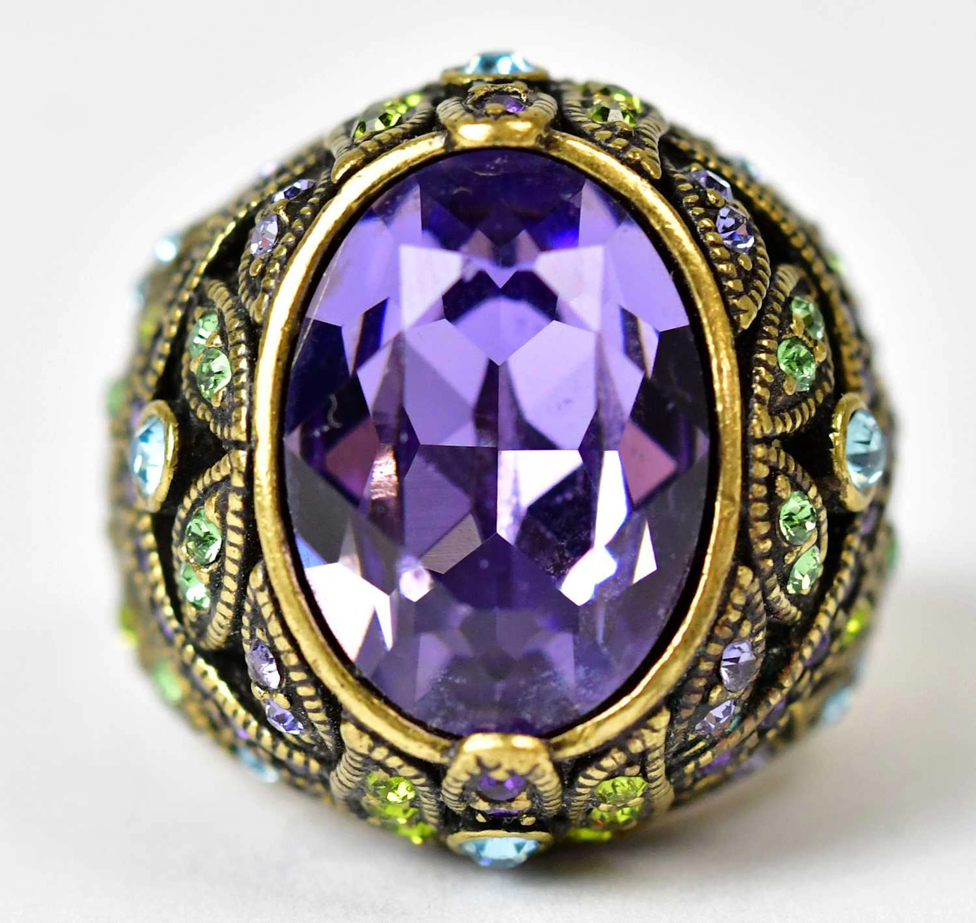 HEIDI DAUS; a gold-coloured ring set with a central oval...