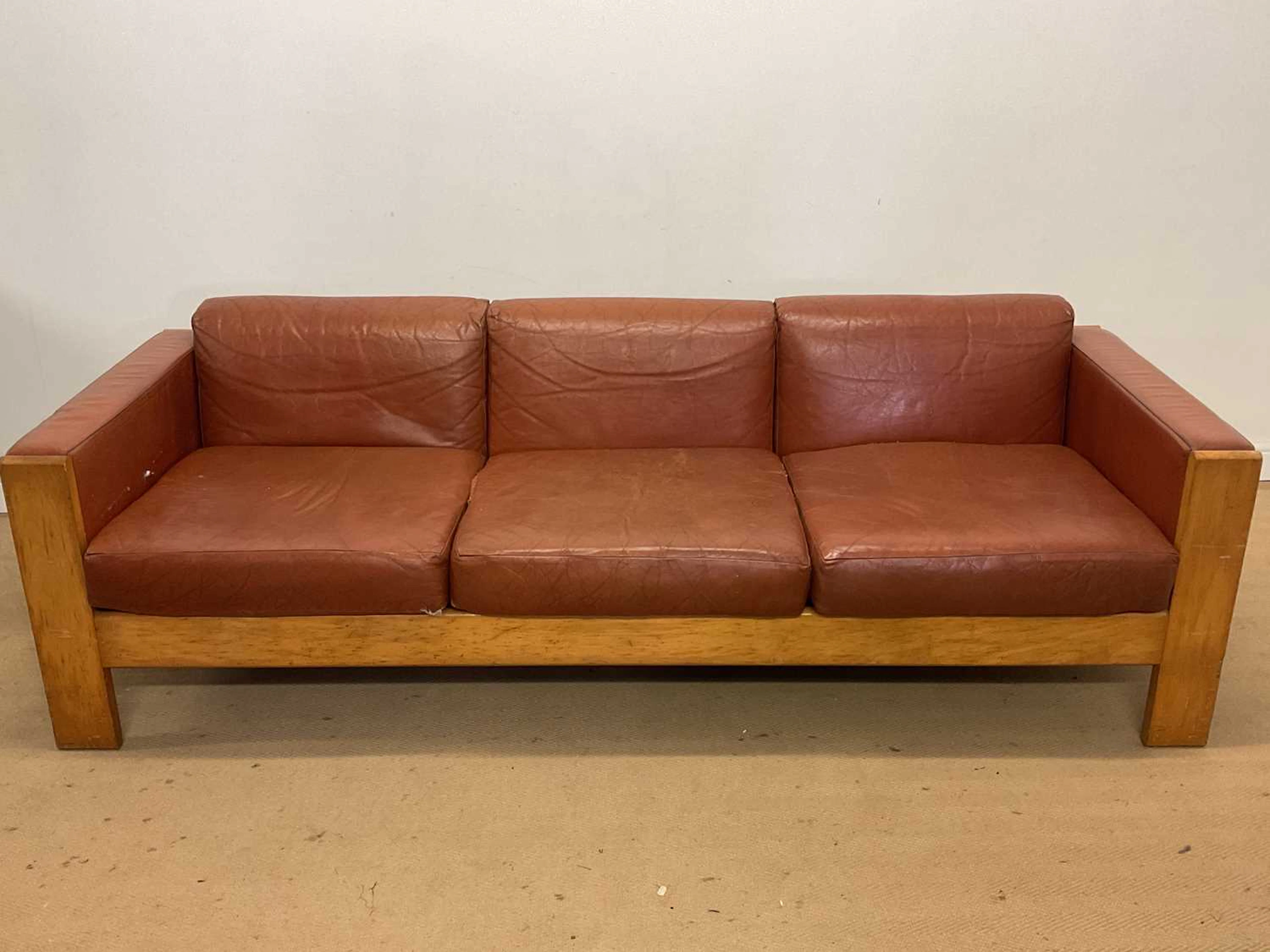 TERENCE CONRAN; a mid 20th century leather and beech framed three piece suite