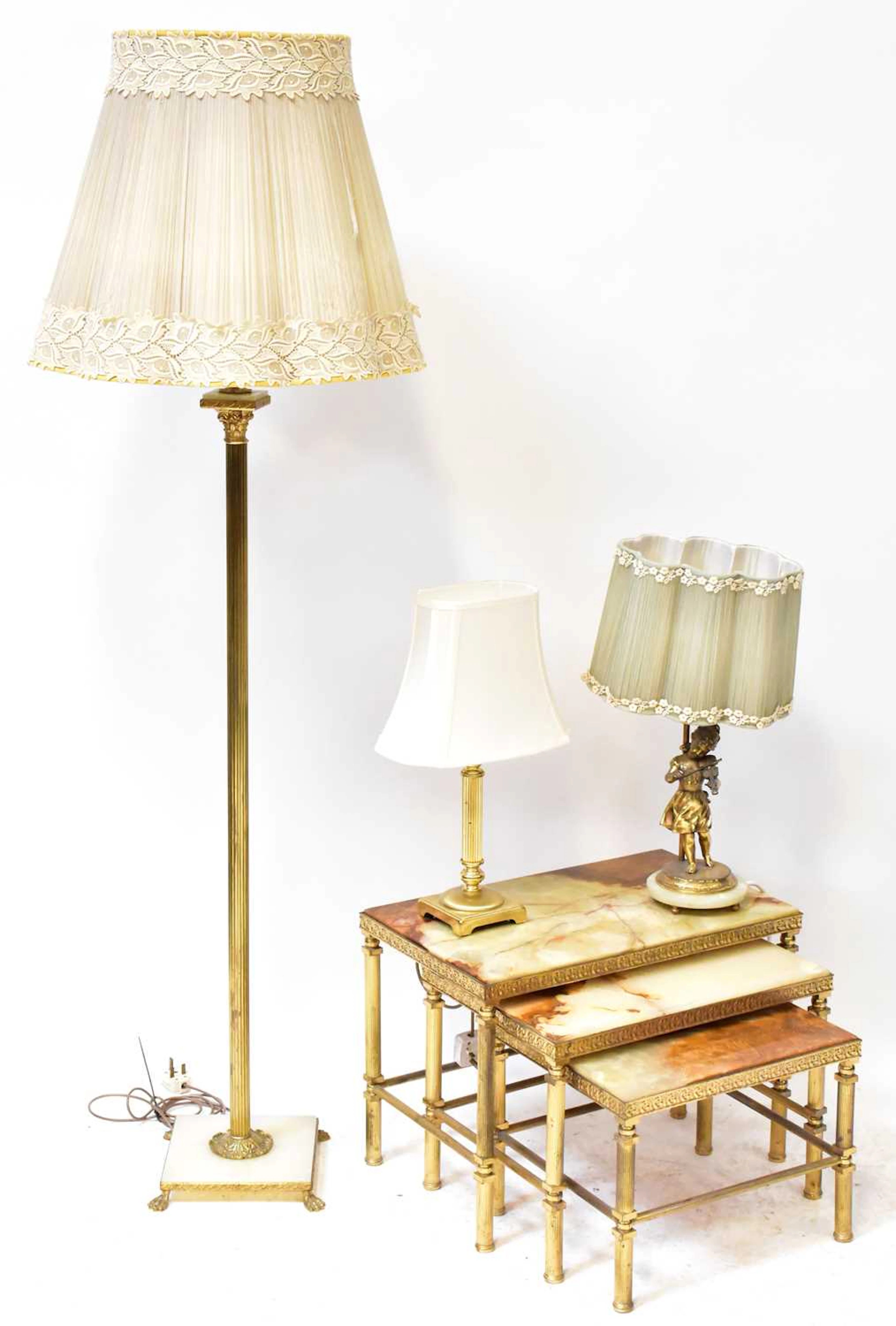 A mid-20th century brass and onyx-topped nest of three tables