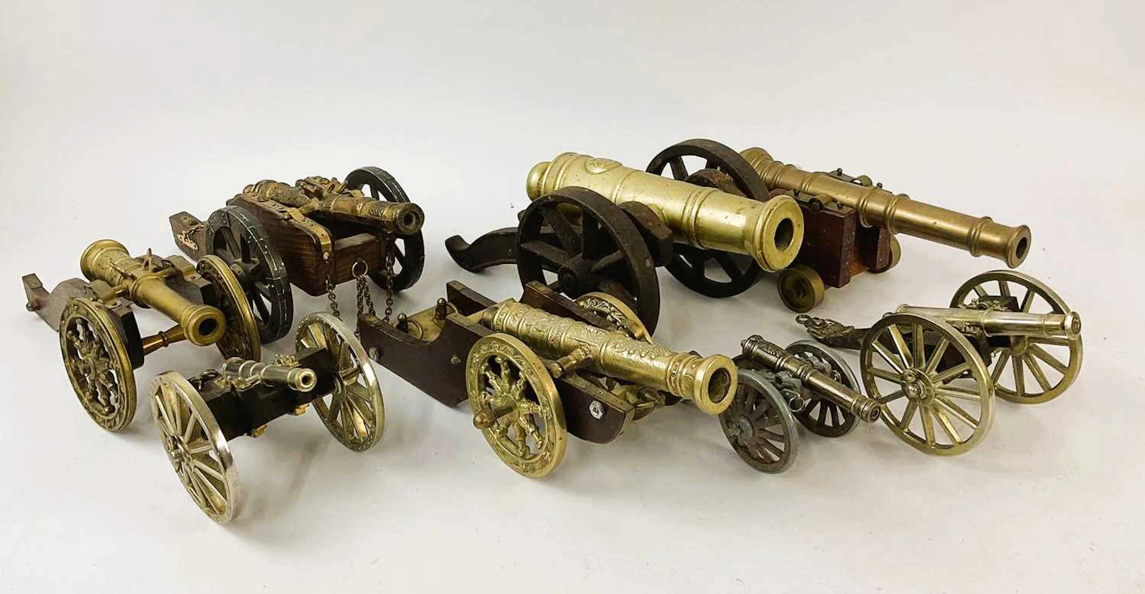 Eight brass and wooden table cannons