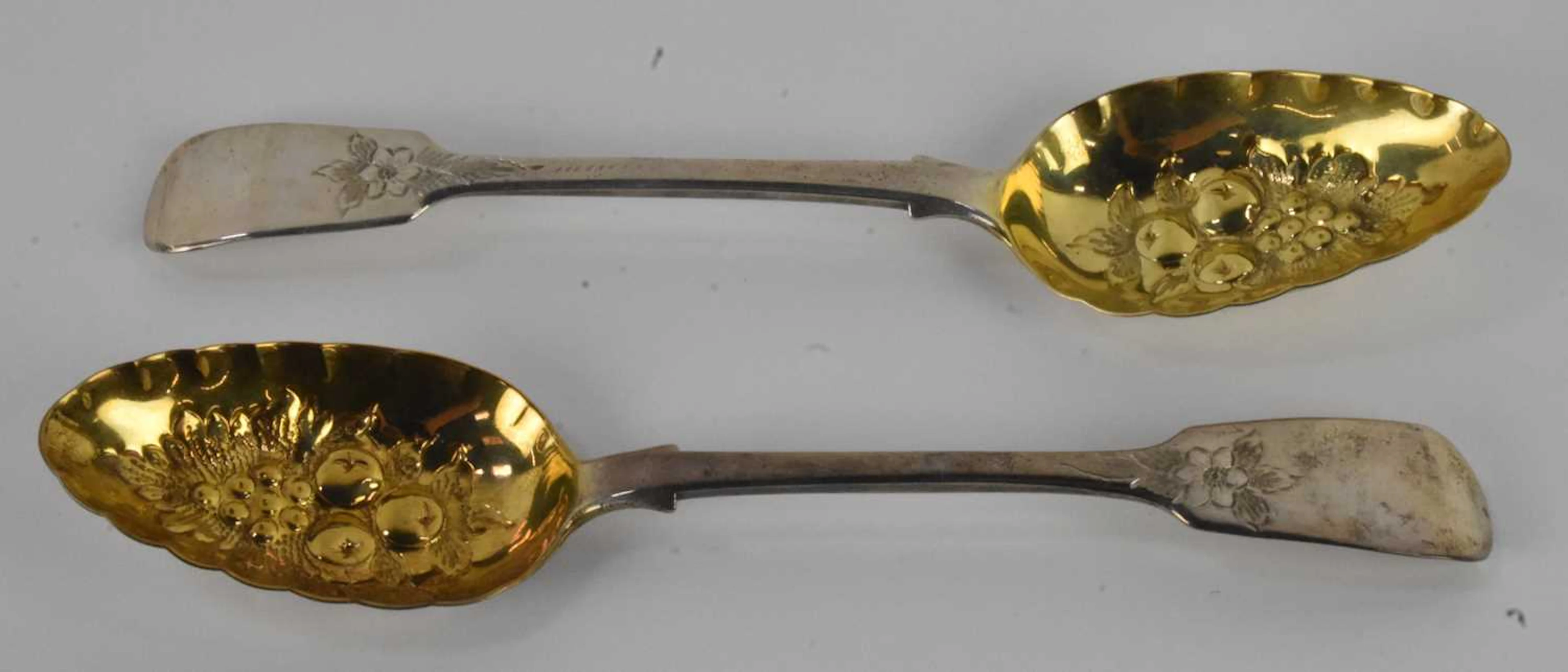 A pair of Victorian hallmarked silver berry spoons with gilt wash bowls