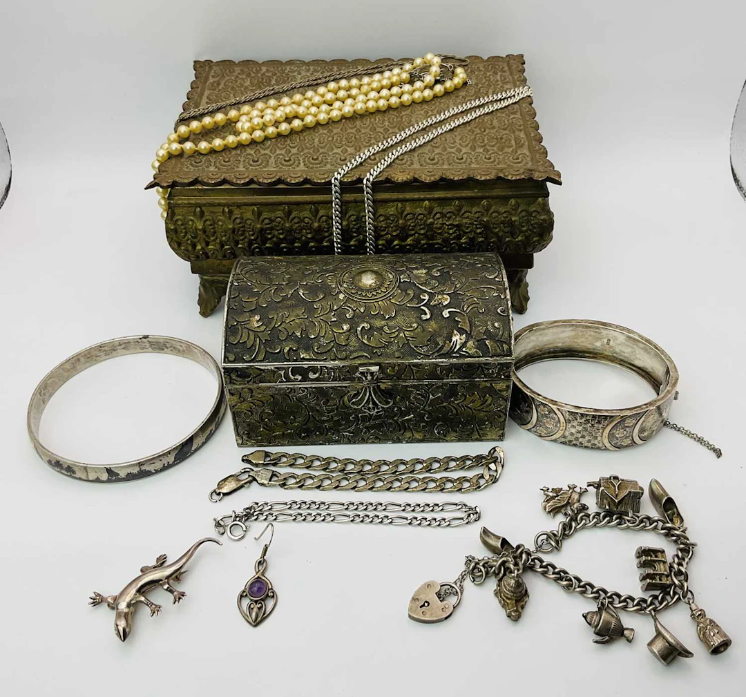 A mixed collection of silver and white metal with two caskets