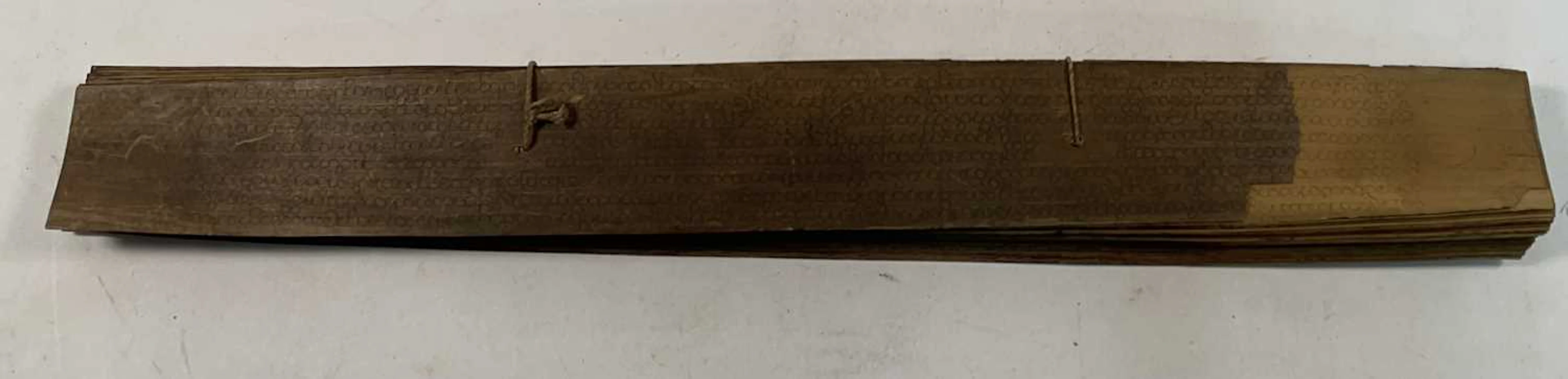A palm leaf book with Buddhist manuscript on...