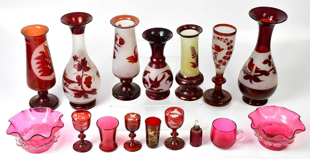 A collection of Victorian and later cranberry glassware including jugs