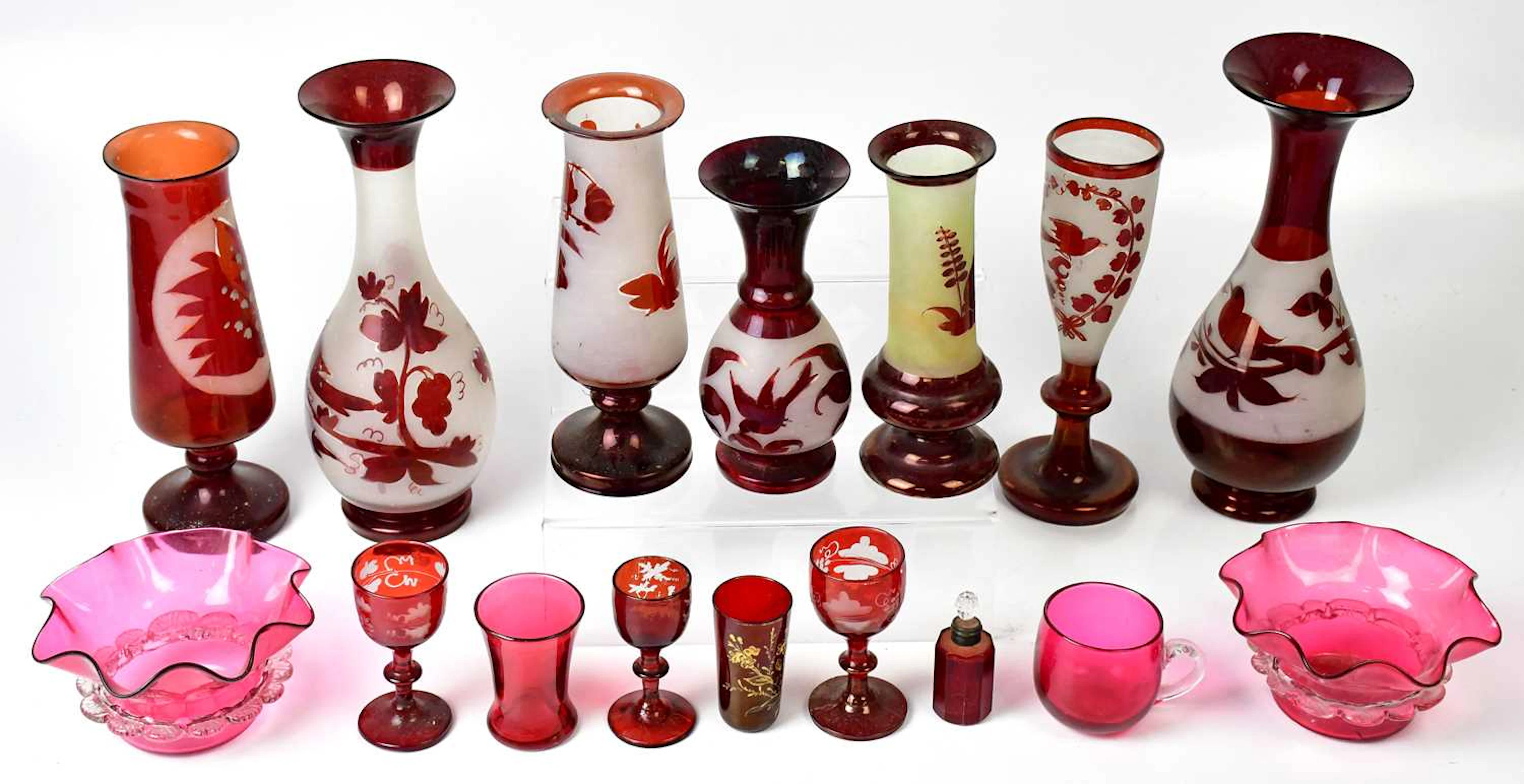 A collection of Victorian and later cranberry glassware including jugs