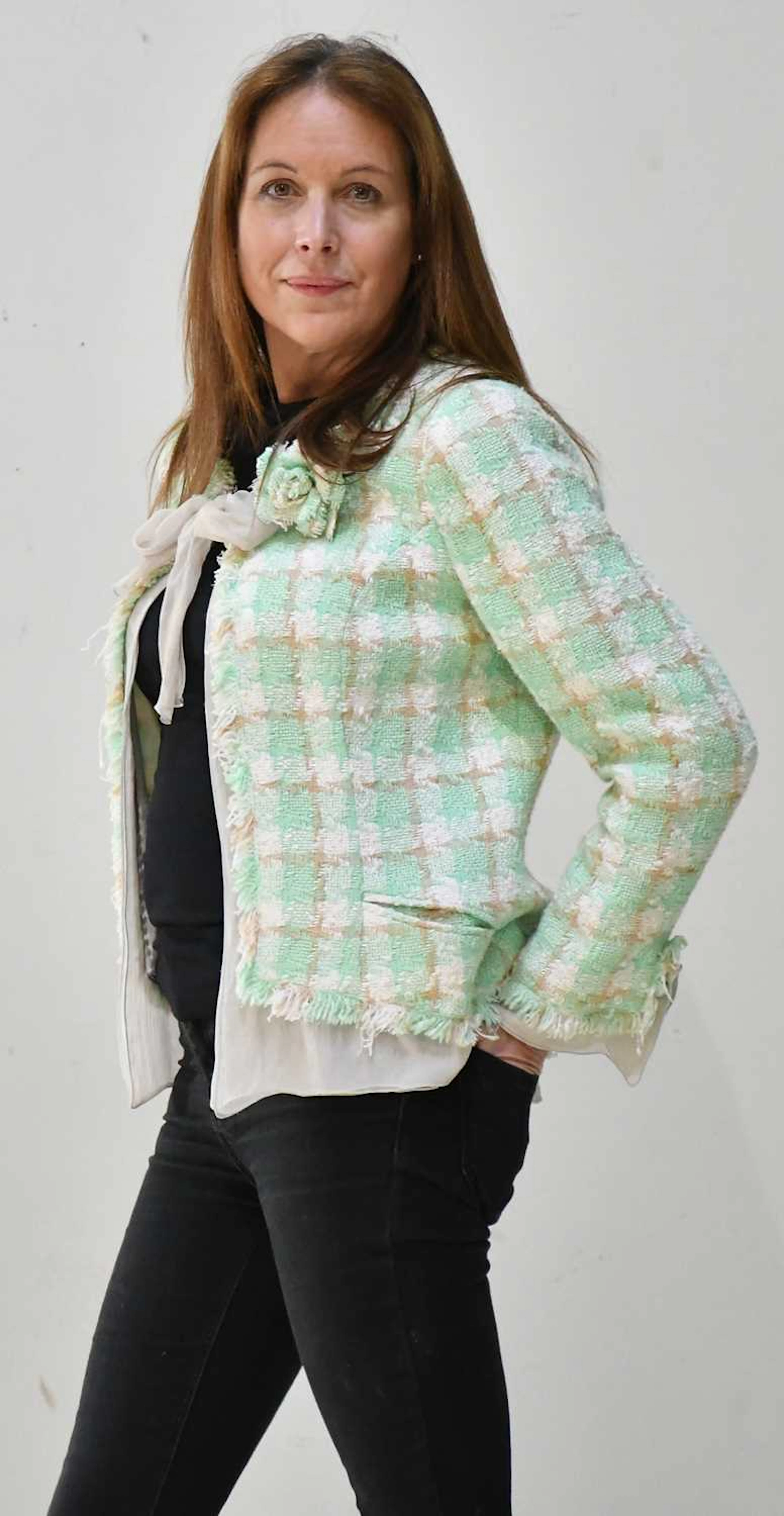 CHANEL; a green and cream bouclé short jacket