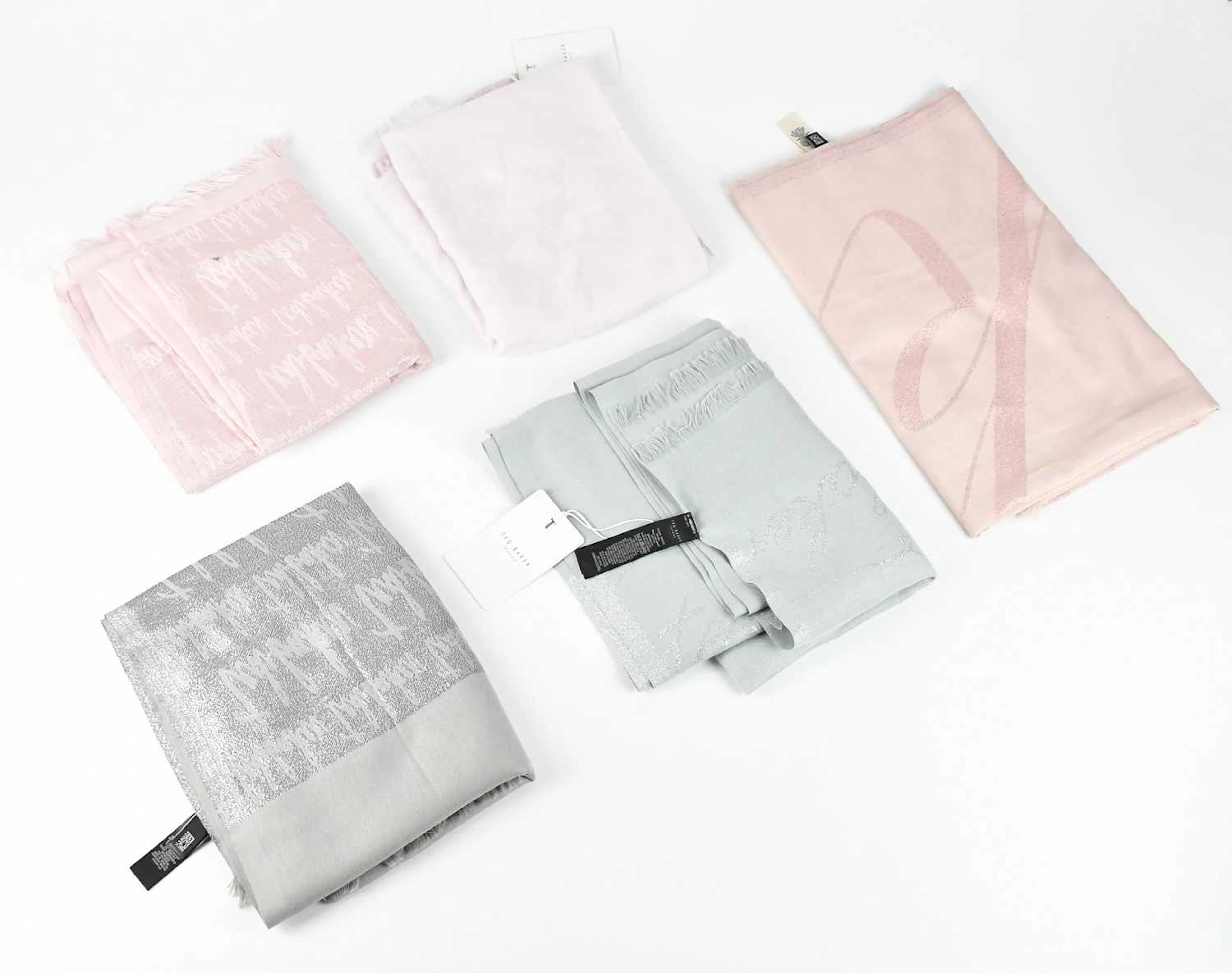 TED BAKER; five scarves comprising three pink scarves...