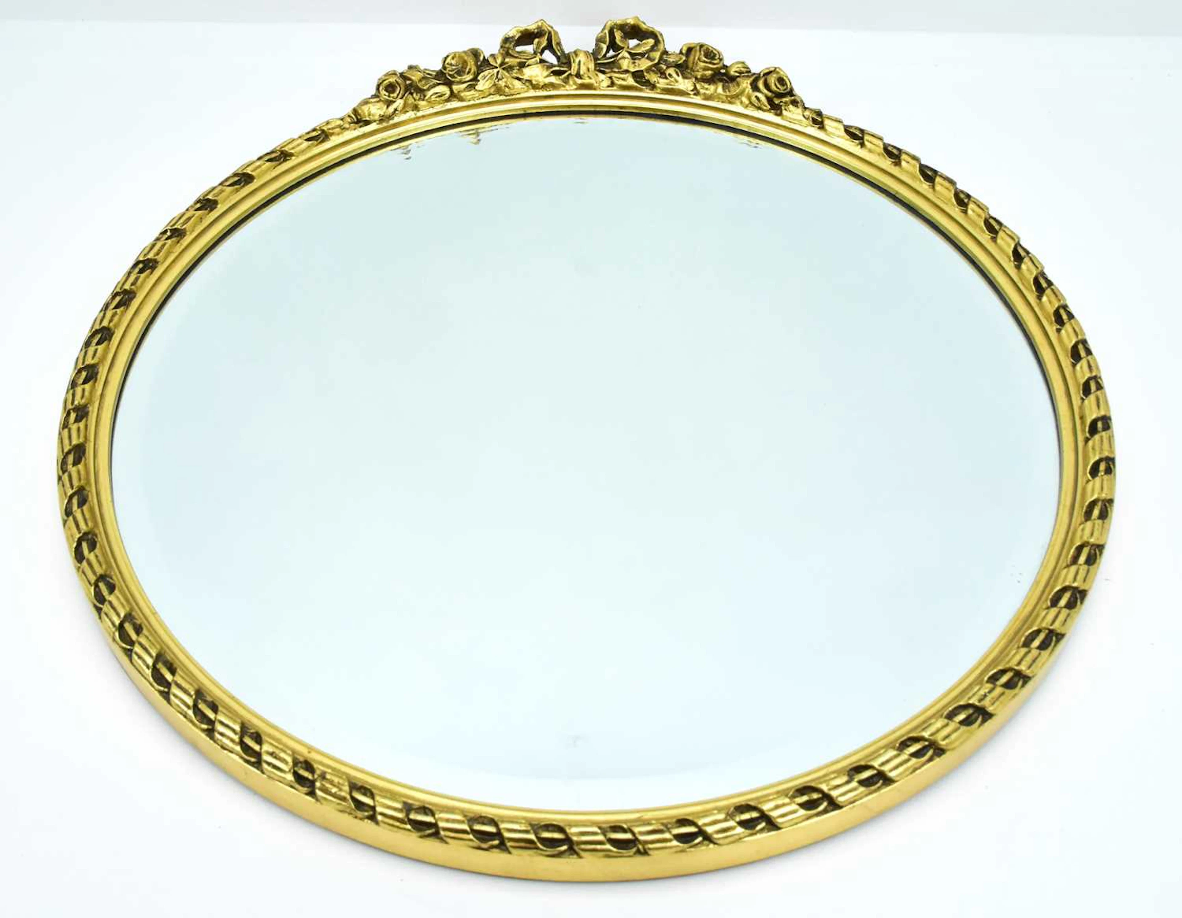 A large circular bevelled edge wall mirror