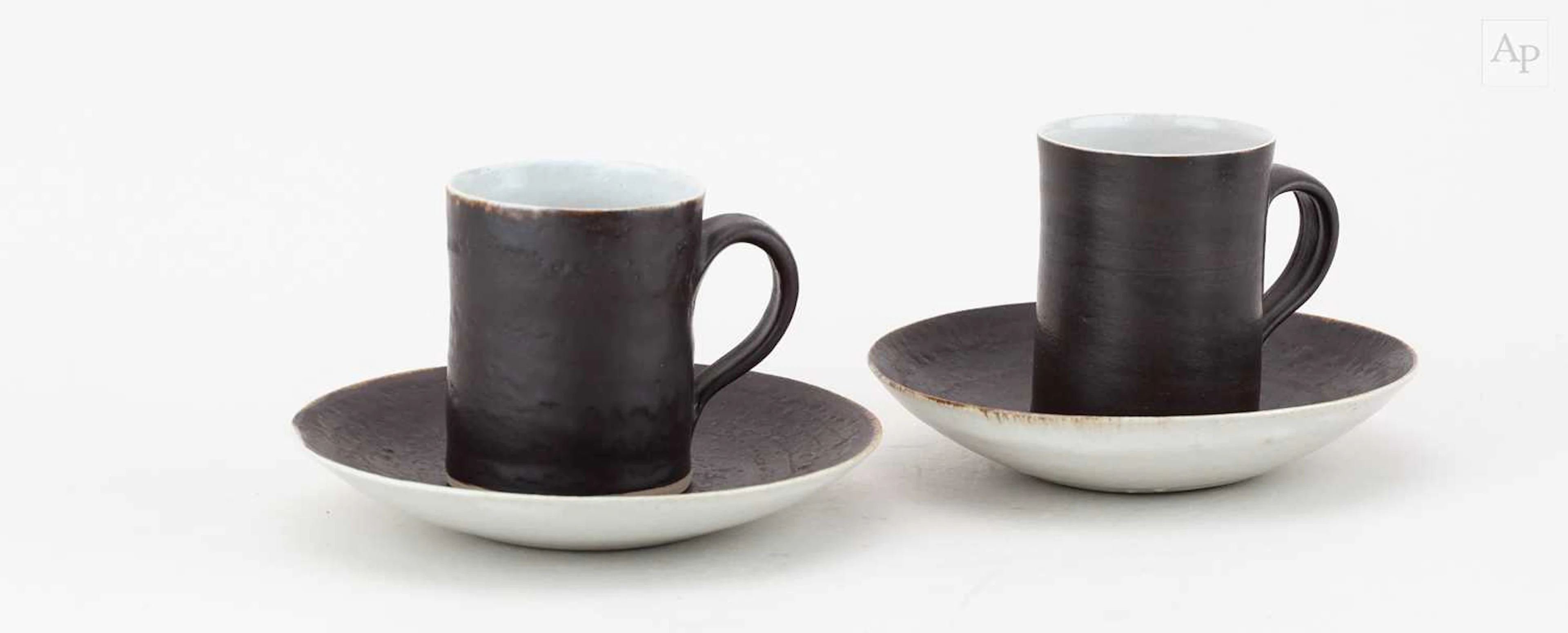 LUCIE RIE (1902-1995); a near pair of stoneware cups and...