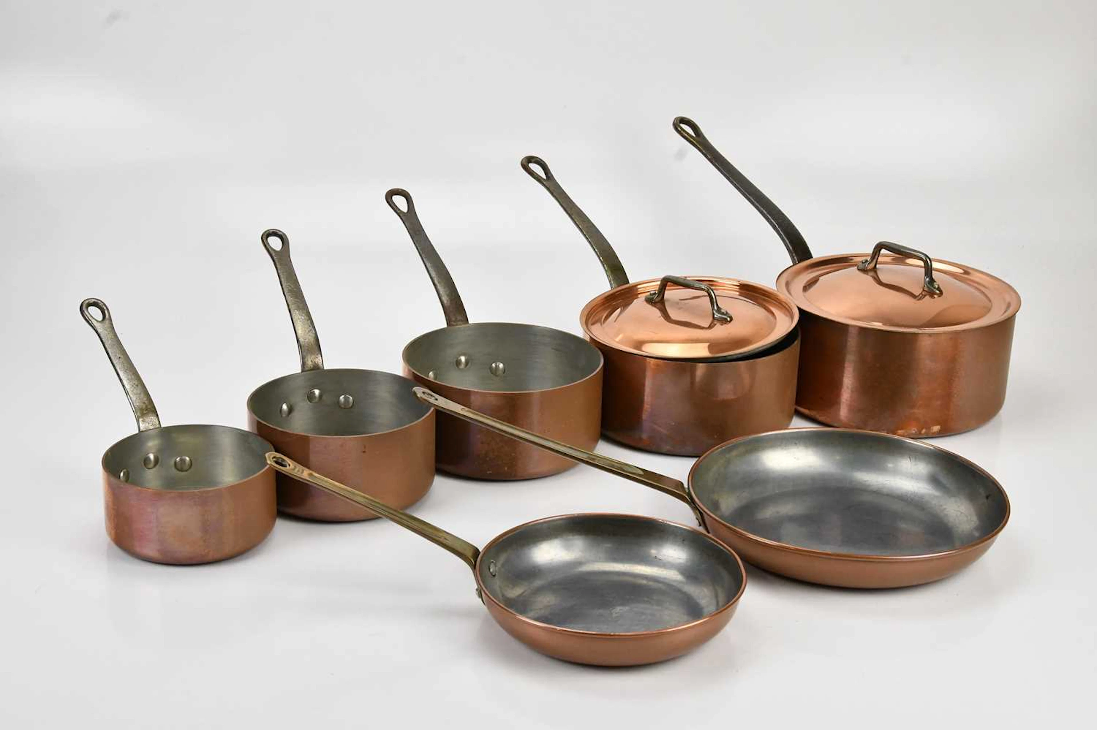 A set of five tin lined copper pans