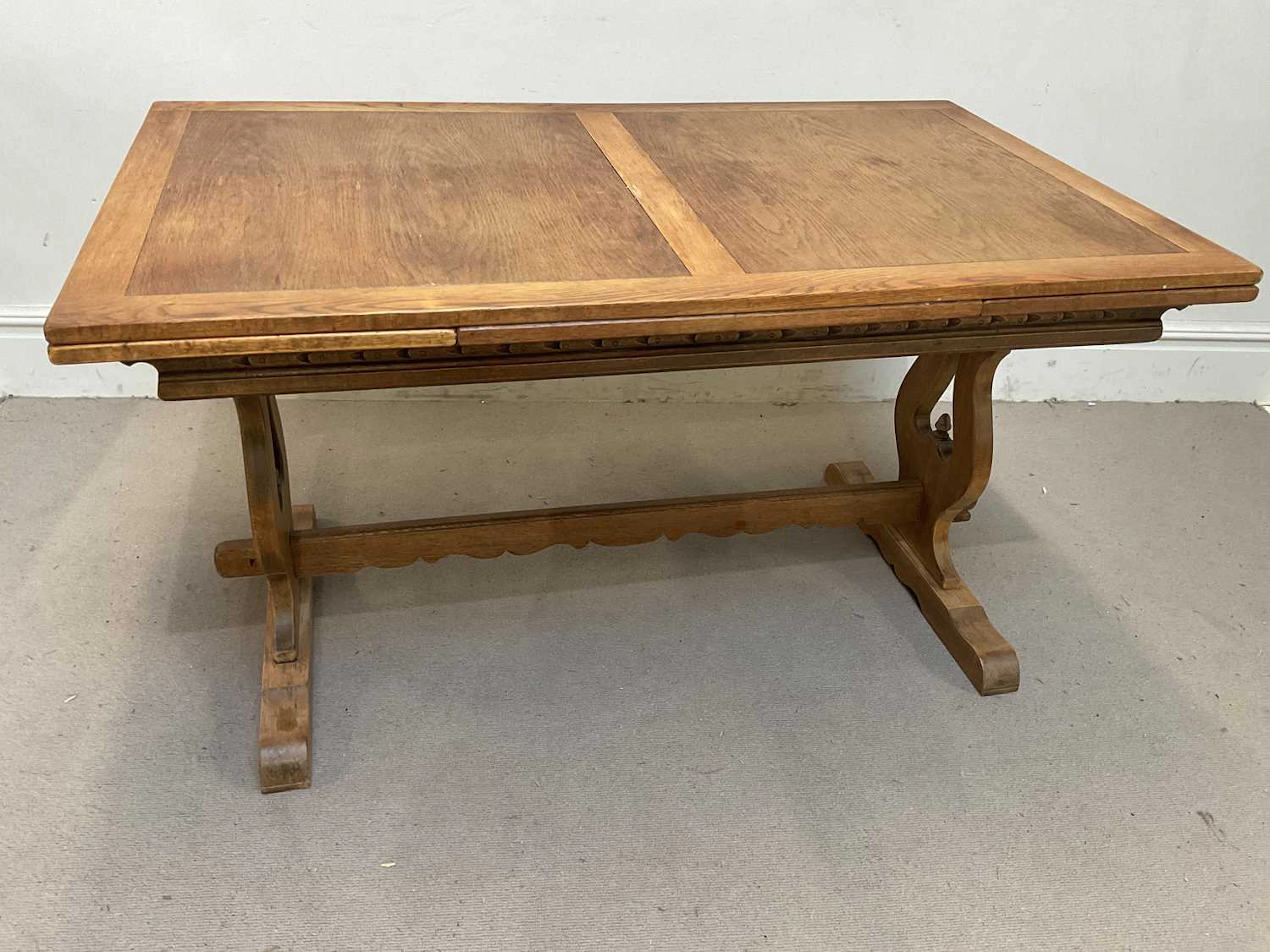 An early 20th century oak extending refectory type table