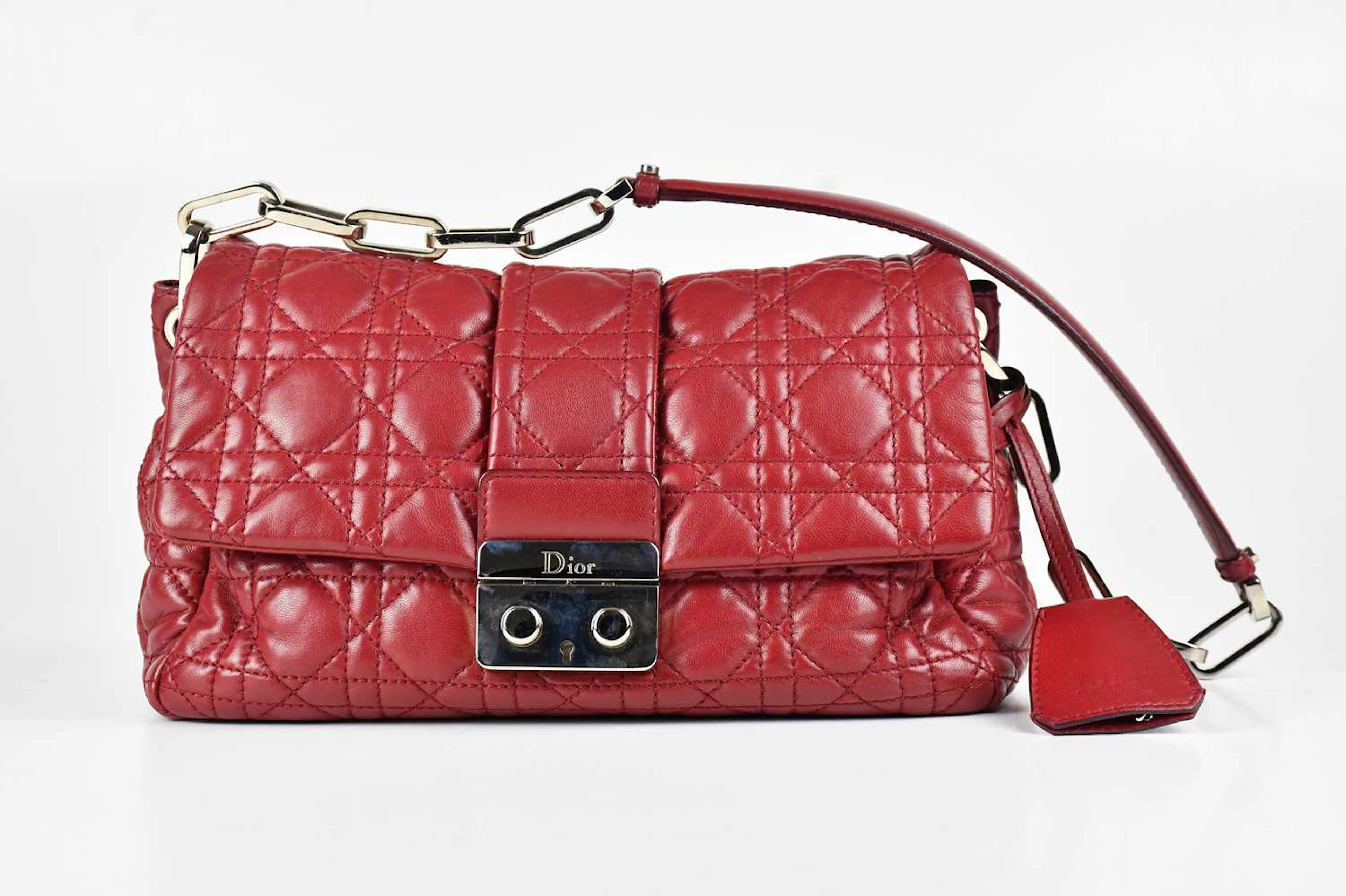 DIOR; a deep red calfskin leather new lock flap bag from the Miss Dior line