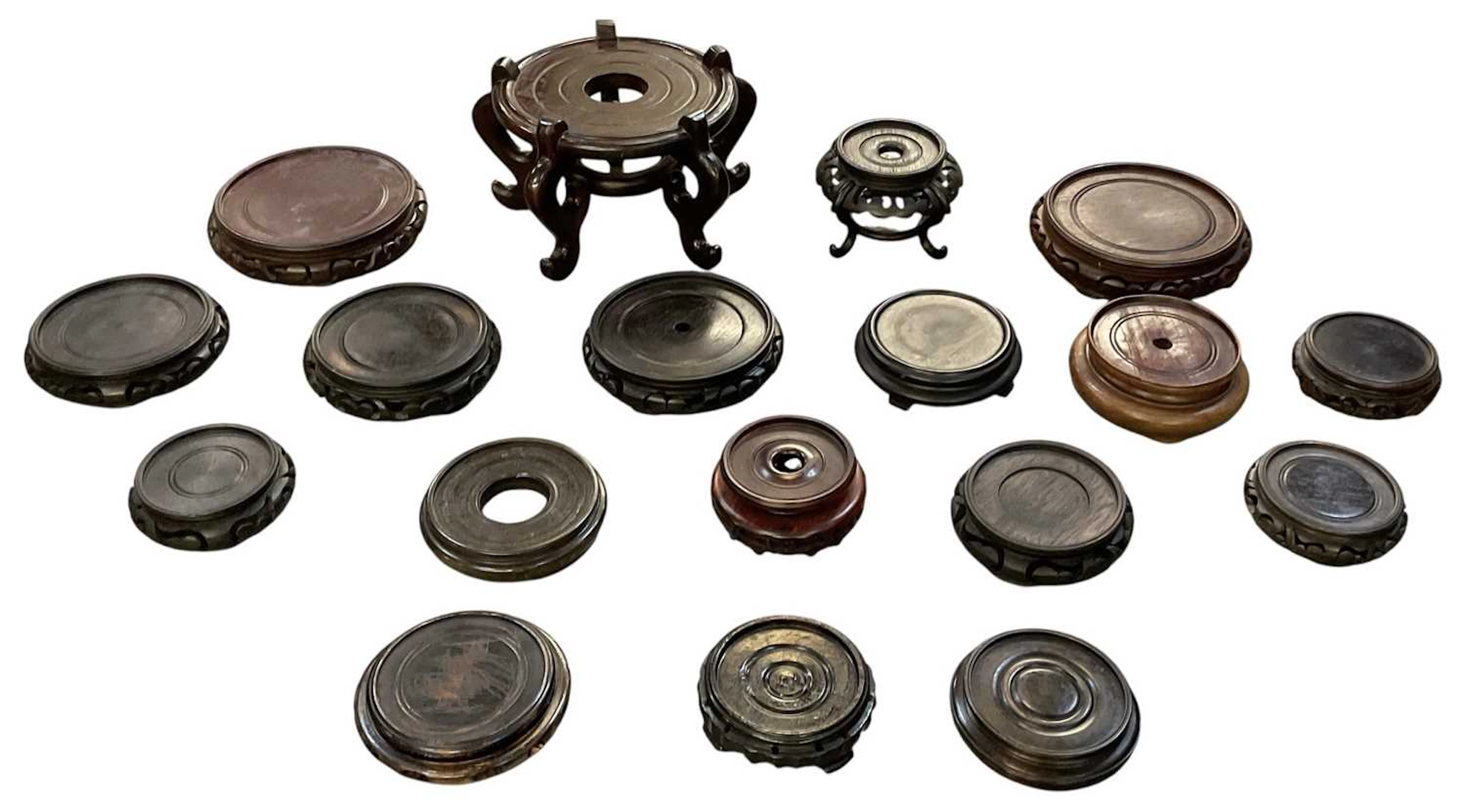 A collection of approximately seventeen Chinese carved hardwood stands