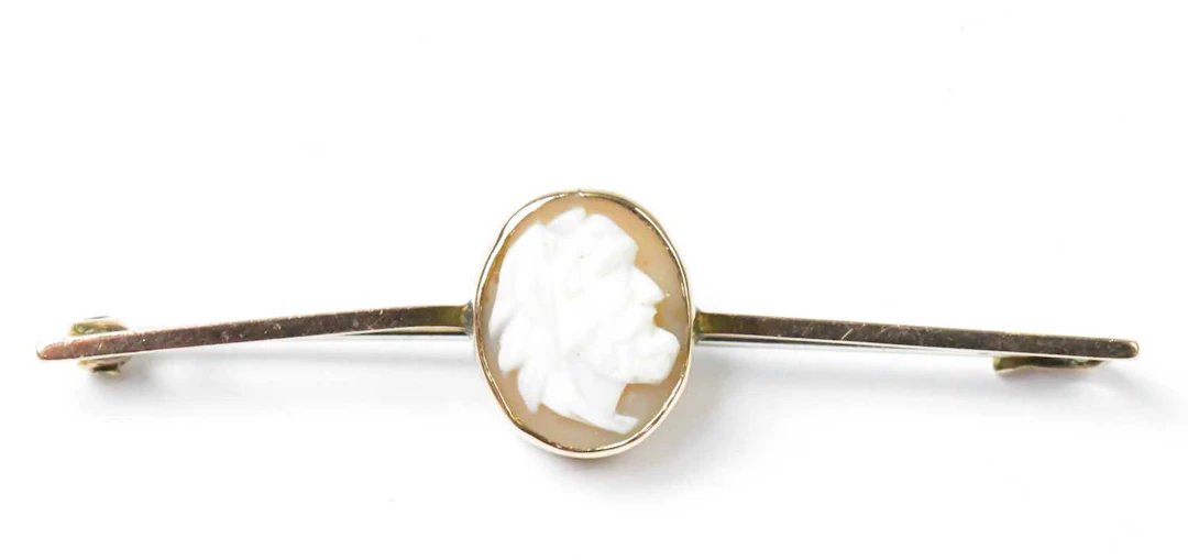 A 9ct yellow gold bar brooch set with an oval cameo...