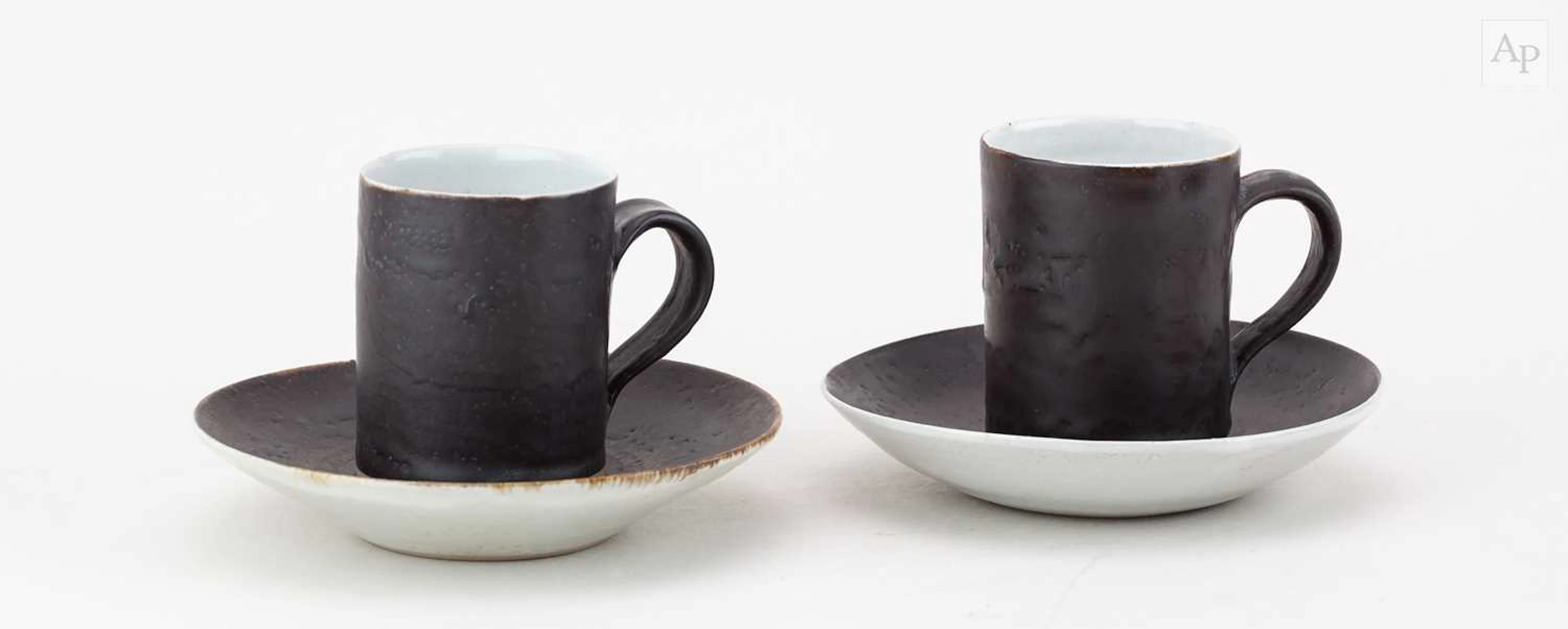 LUCIE RIE (1902-1995); a near pair of stoneware cups and...