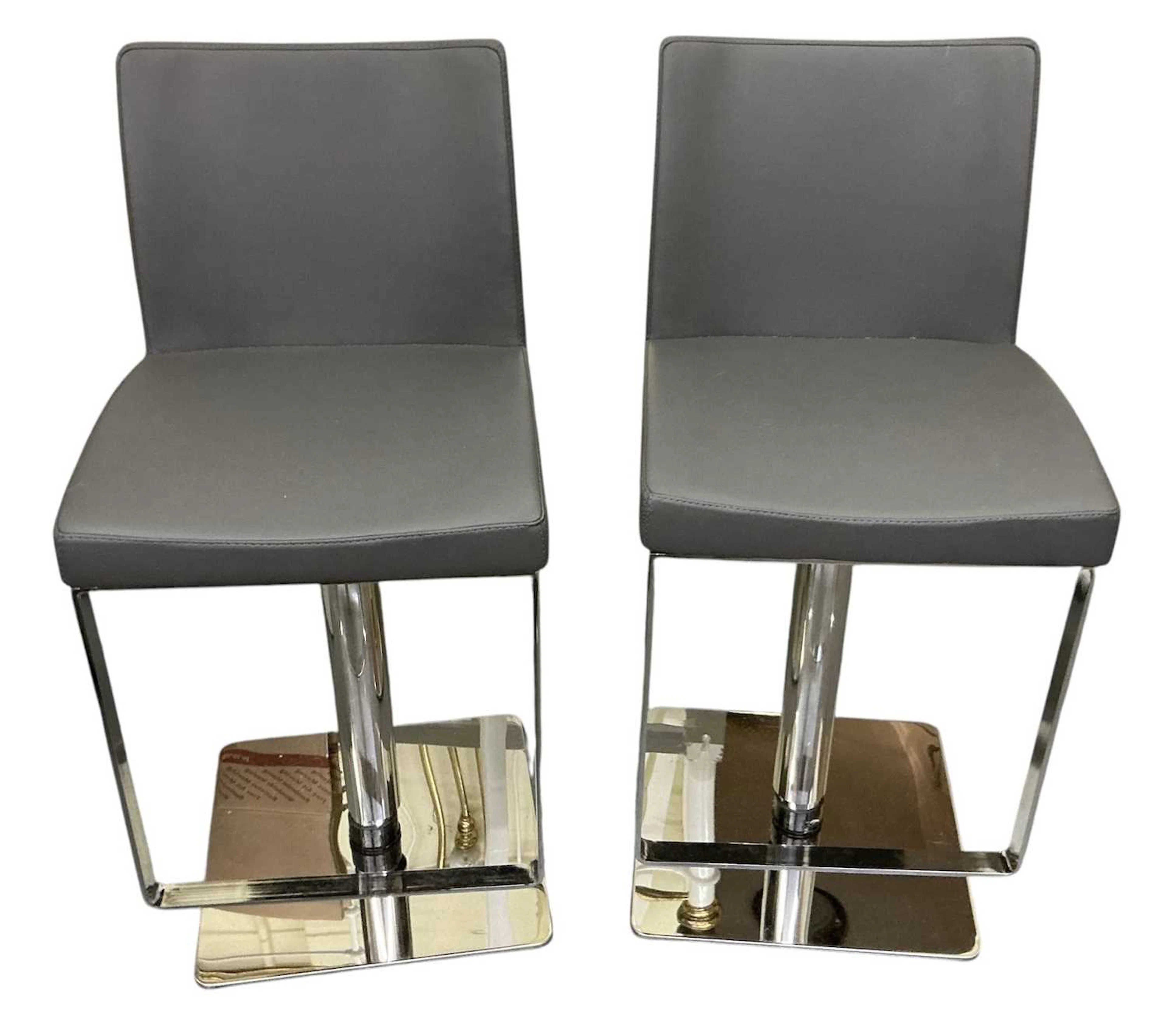 A pair of modern contemporary grey upholstered chrome...