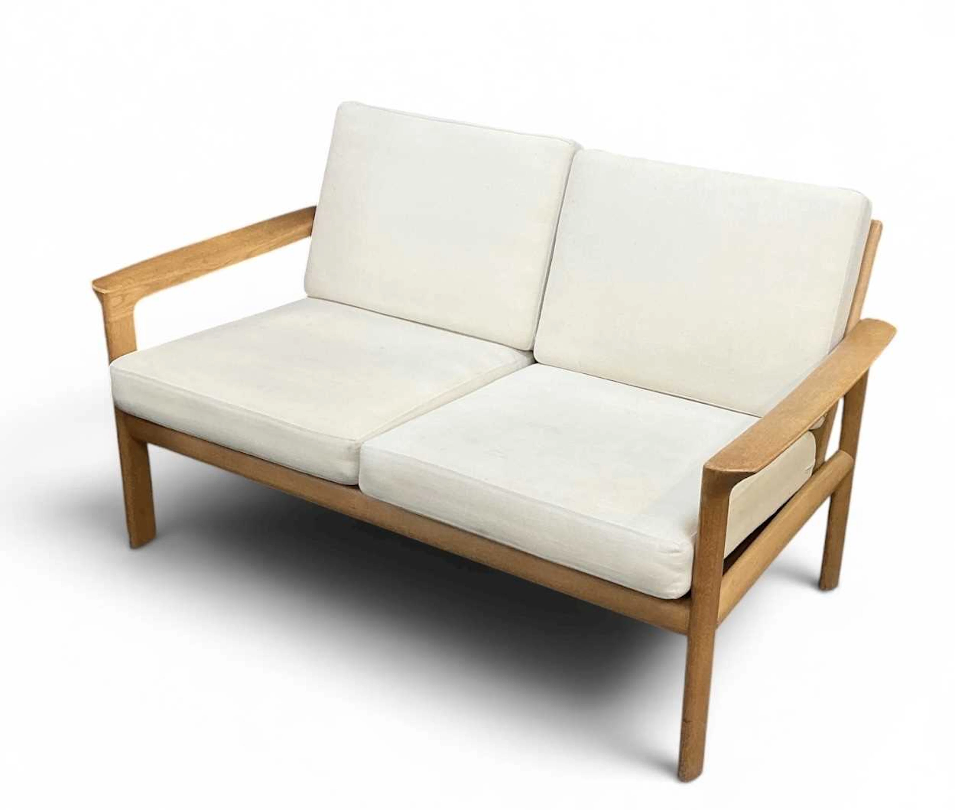 A modern Danish light oak framed two seater sofa